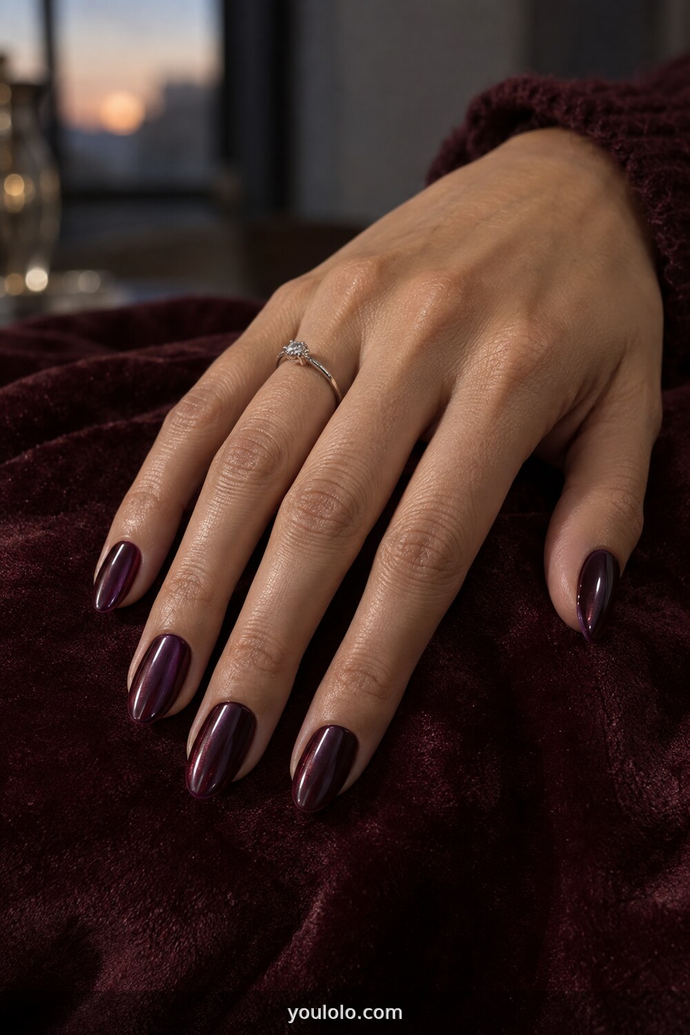 Deep plum glass nails with a subtle chrome glow