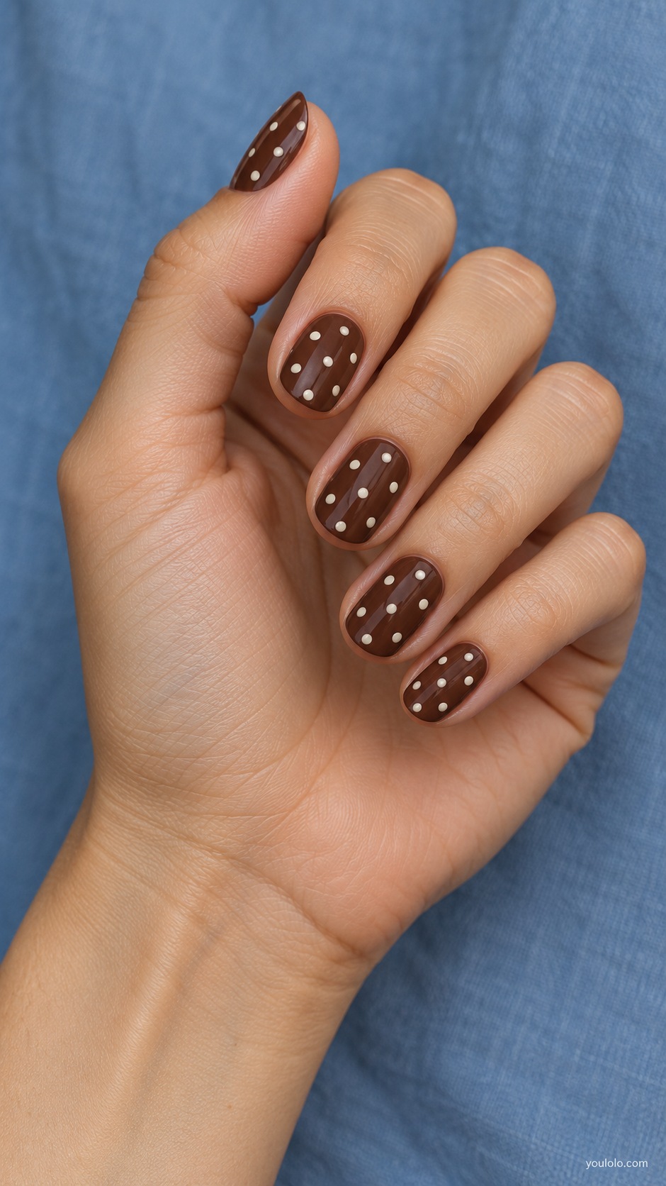 Cream Dots on Cocoa — short oval cocoa brown cream nails evenly spaced small ivory polka dots