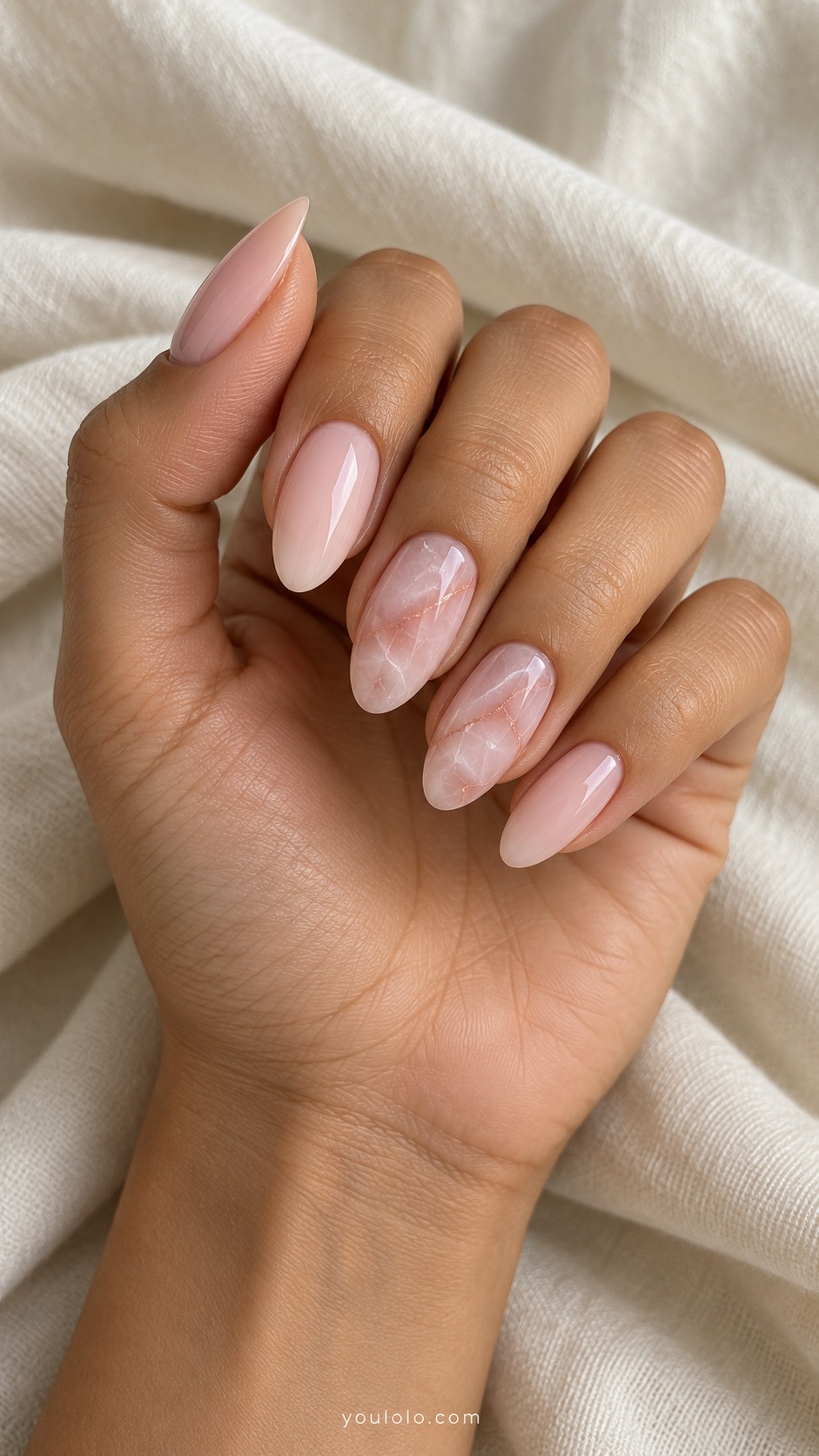 Medium almond acrylic extensions milky blush with translucent rose quartz veining on middle and ring nails glossy