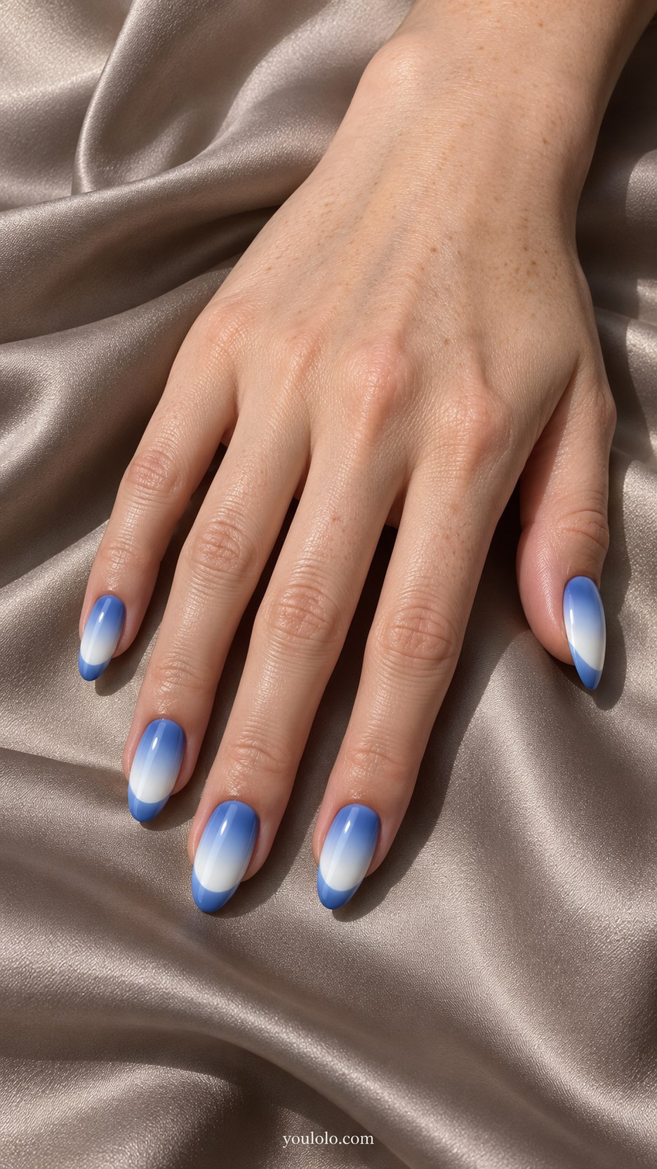 Reverse-Gradient French: medium almond nails, blue to white vertical gradient with French tip reversing the gradient direction, perfectly flat polish