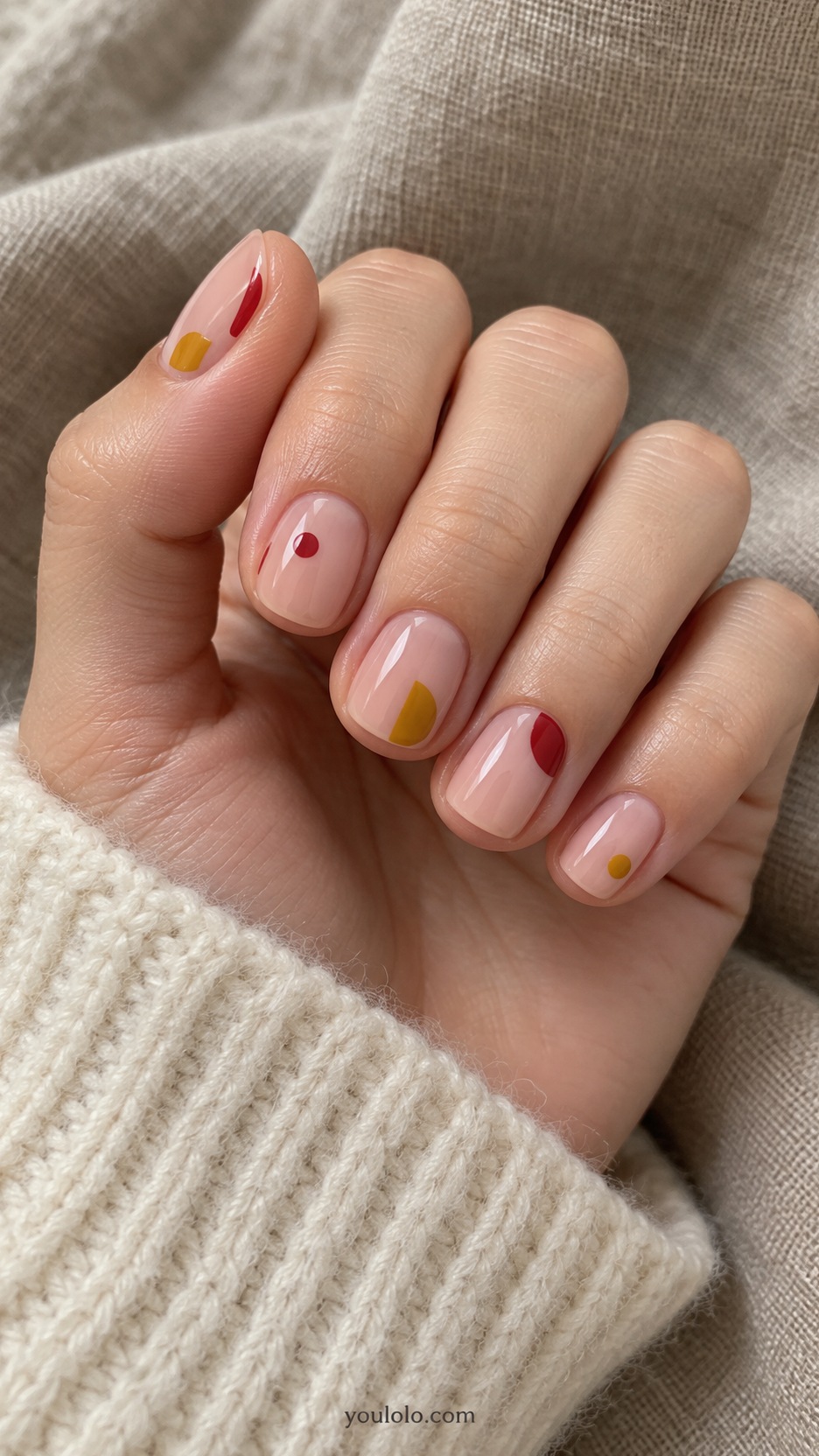 Short Artsy Nails: Primary Color Cutouts manicure on a naturally posed hand