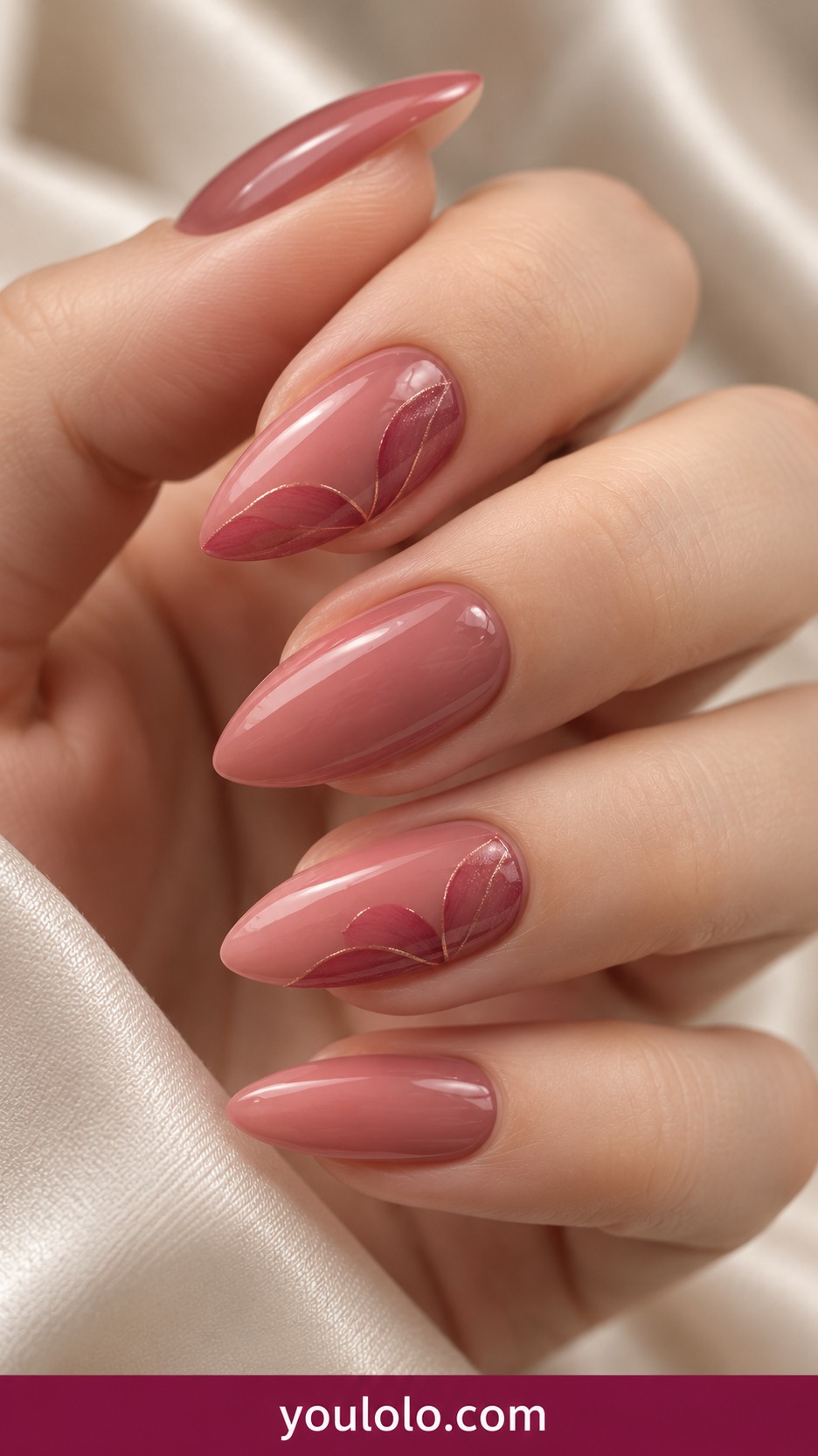 Medium almond dusty rose nails with darker rose curved petal edge on two accents on a naturally curled young adult hand