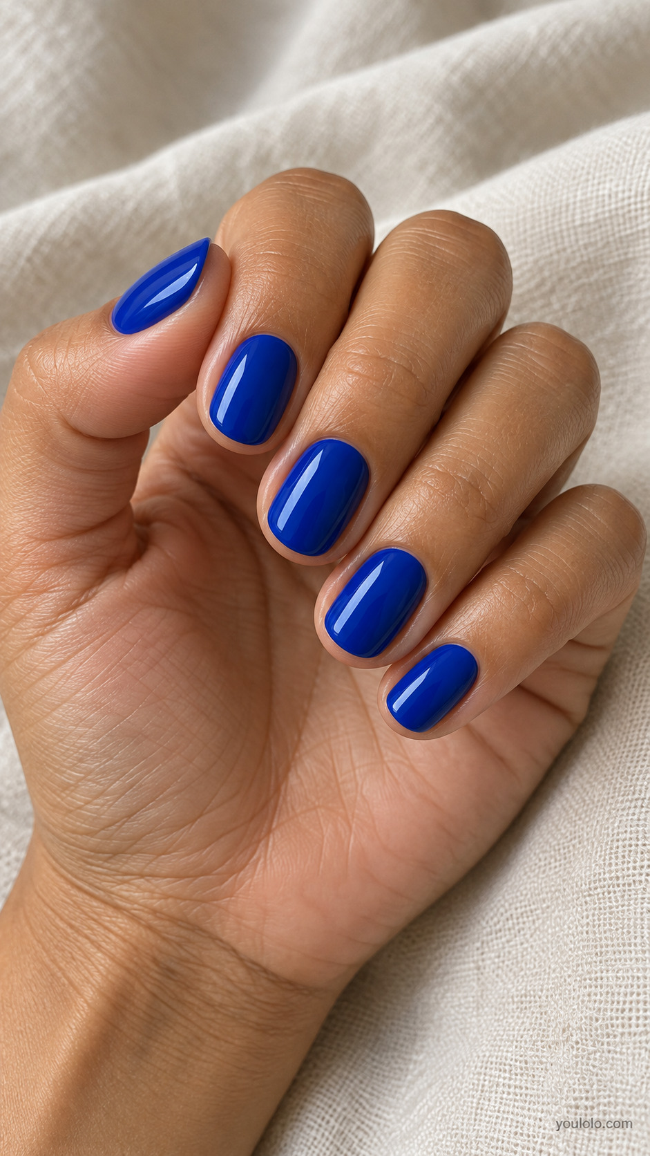 Short rounded nails in solid glossy royal blue