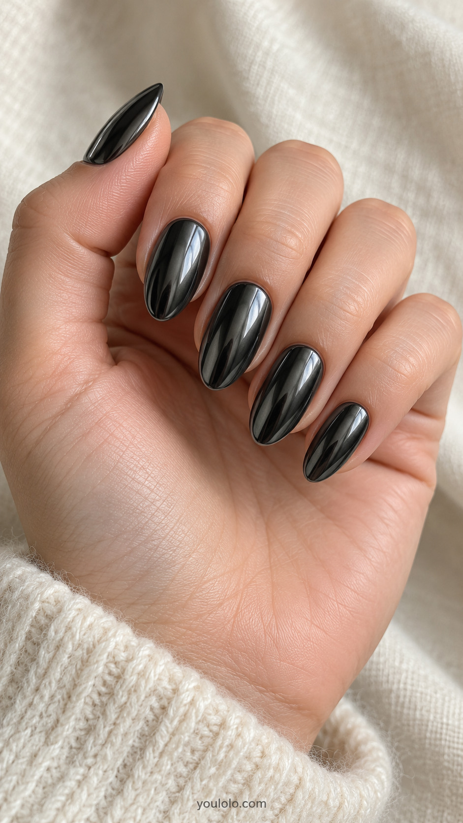 Medium almond nails entirely dark charcoal gunmetal mirror chrome, subtle black edges with steel-grey reflection, no motifs