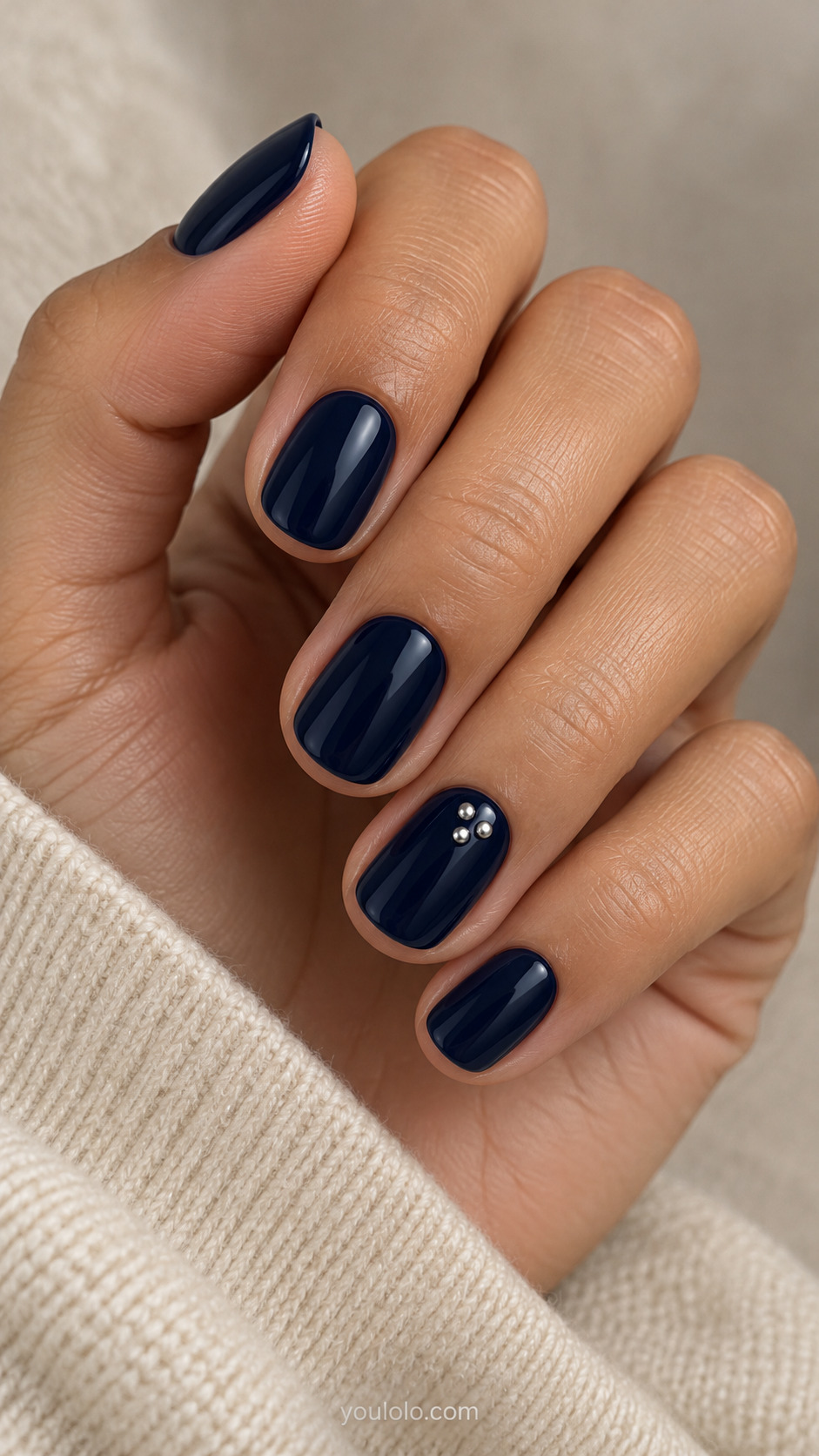 Midnight Blue with a Tiny Silver Stud Trio on a naturally posed hand, showing dark blue polish and detailed nail art