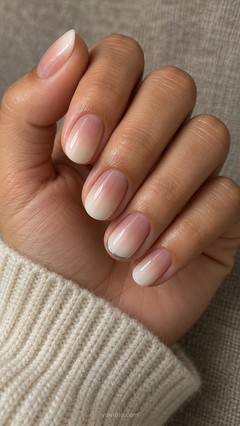 Short pink-to-milky-white ombre nails with a fine silver edge on one nail