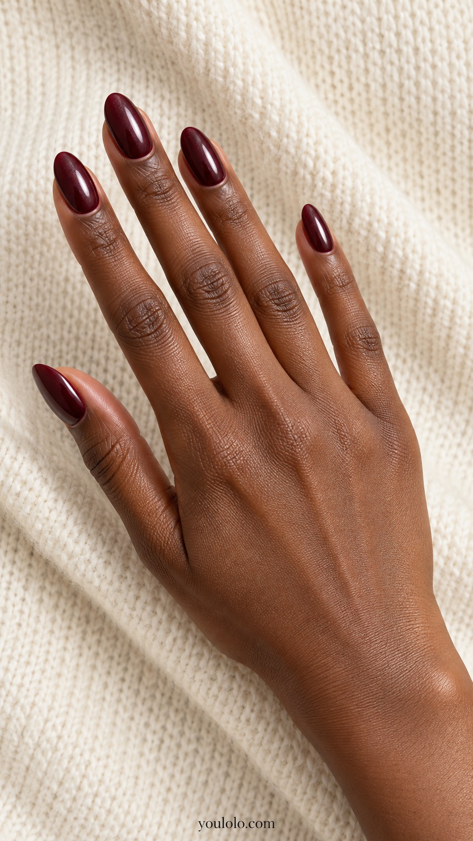 Medium almond nearly black cherry burgundy base with fine cool pearl reflection, no mirror metal