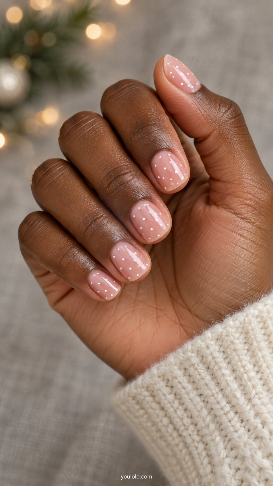 Short squoval sheer pink nails irregular tiny white painted dots, no snowflake linework