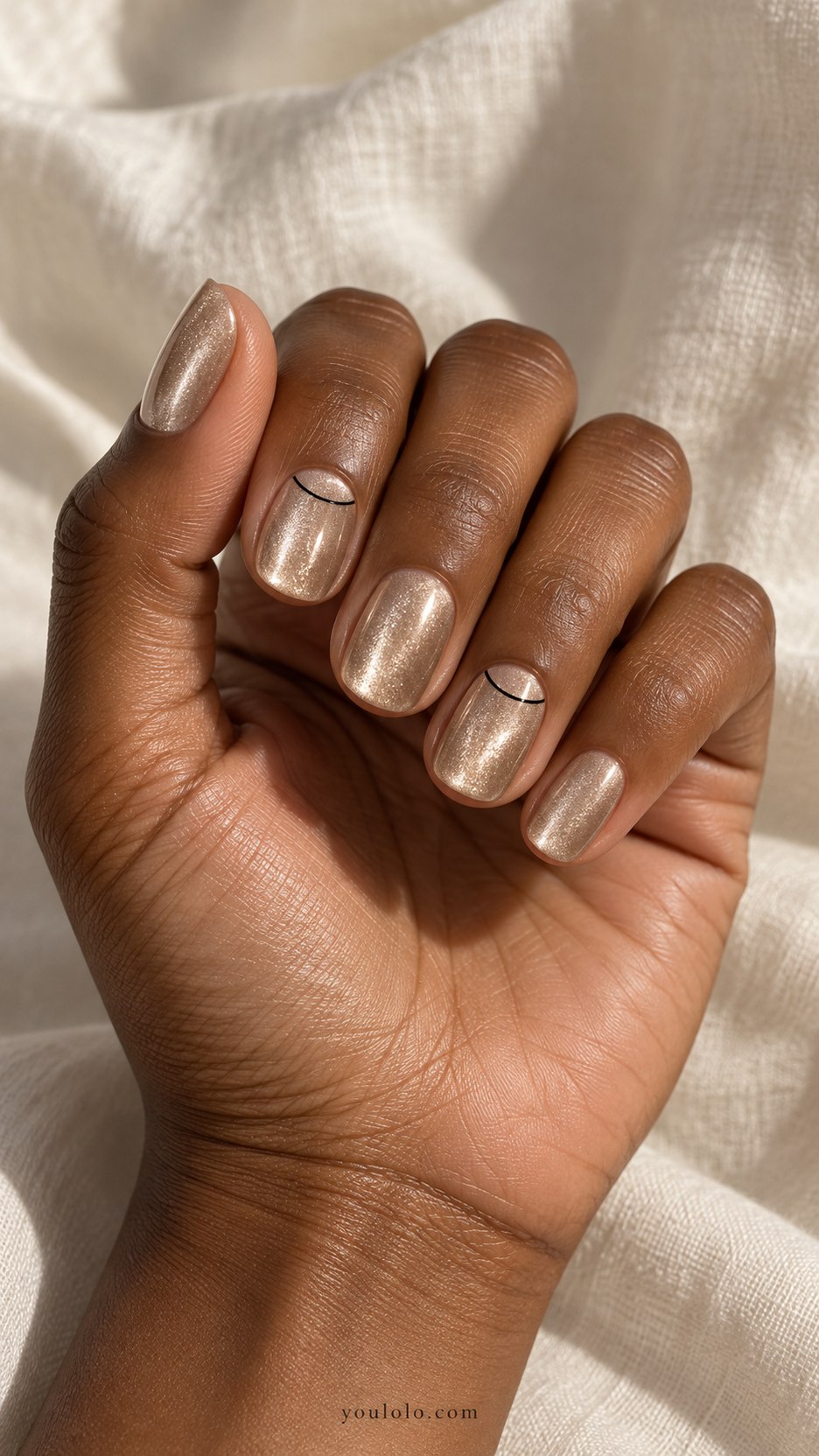 Champagne Velvet Half-Moon Outline: short oval champagne magnetic velvet nails, fine black half-moon outline near base on two accents