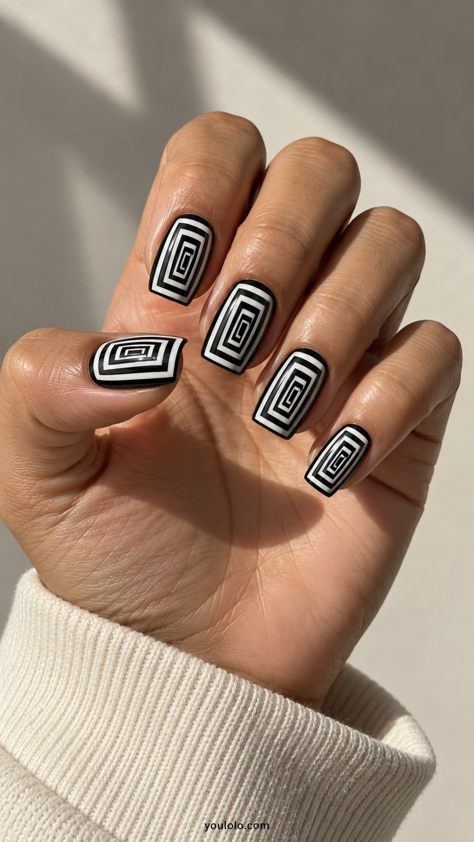 Black-and-White Tunnel: medium square nails, concentric black white rectangular frames shrinking toward offset center creating tunnel illusion, flat paint