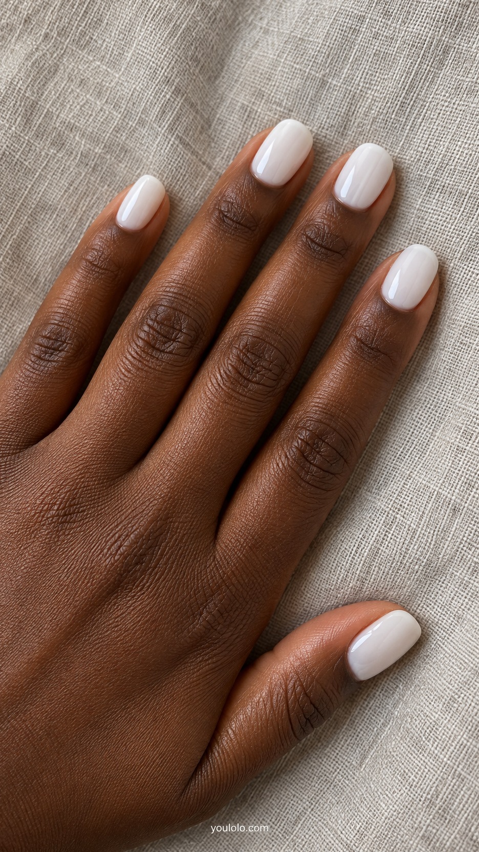 Short Press-On Nails: Soft White Oval manicure on a naturally posed hand