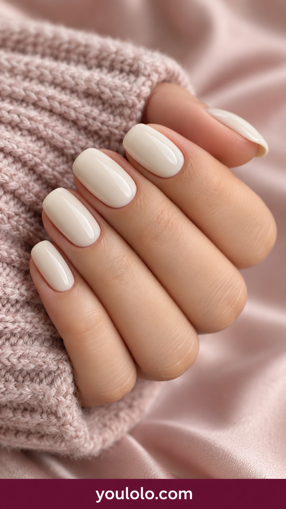 Short oval creamy ivory nails glossy no shimmer no decorations on a naturally curled young adult hand