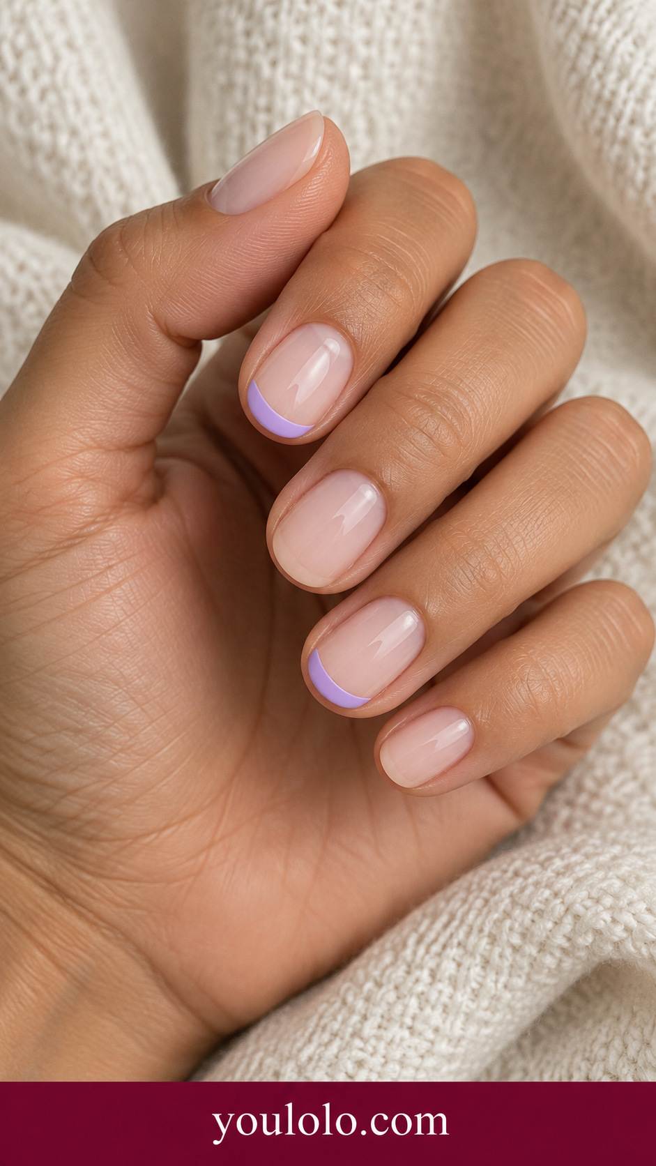 Lilac Open Arch: short oval milky nude nails small flat lilac open semicircle near tip on ring and index only on a naturally posed adult hand