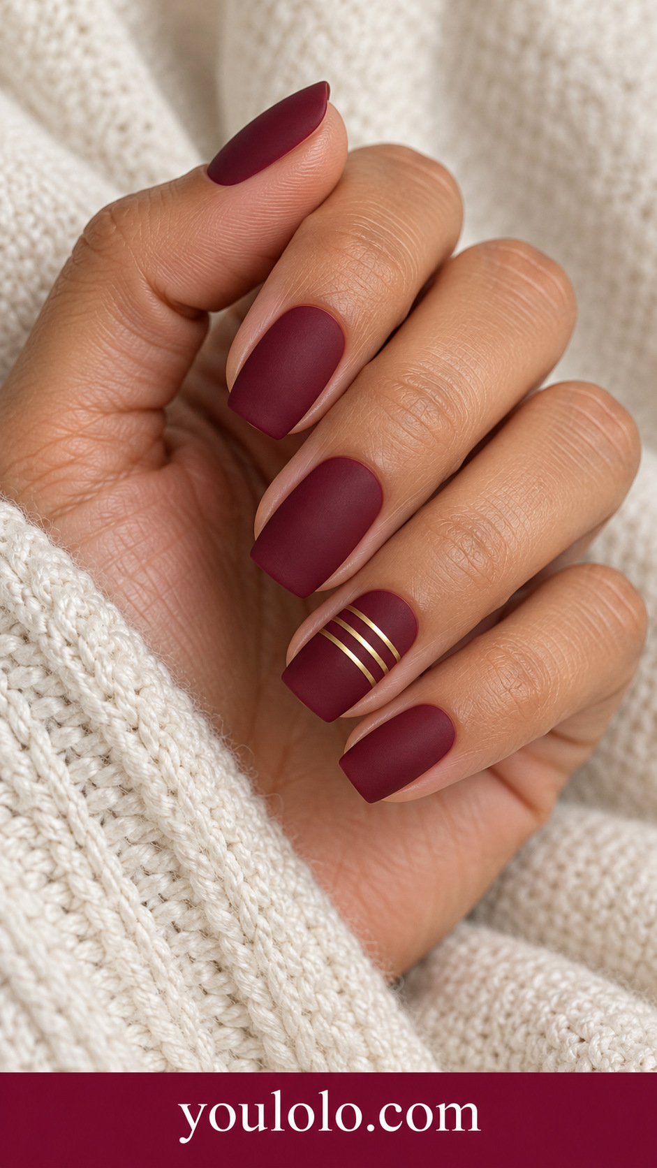 Wine Brass Ladder: medium soft square matte maroon nails ring nail three thin parallel flat brass gold horizontal bars on a naturally posed adult hand