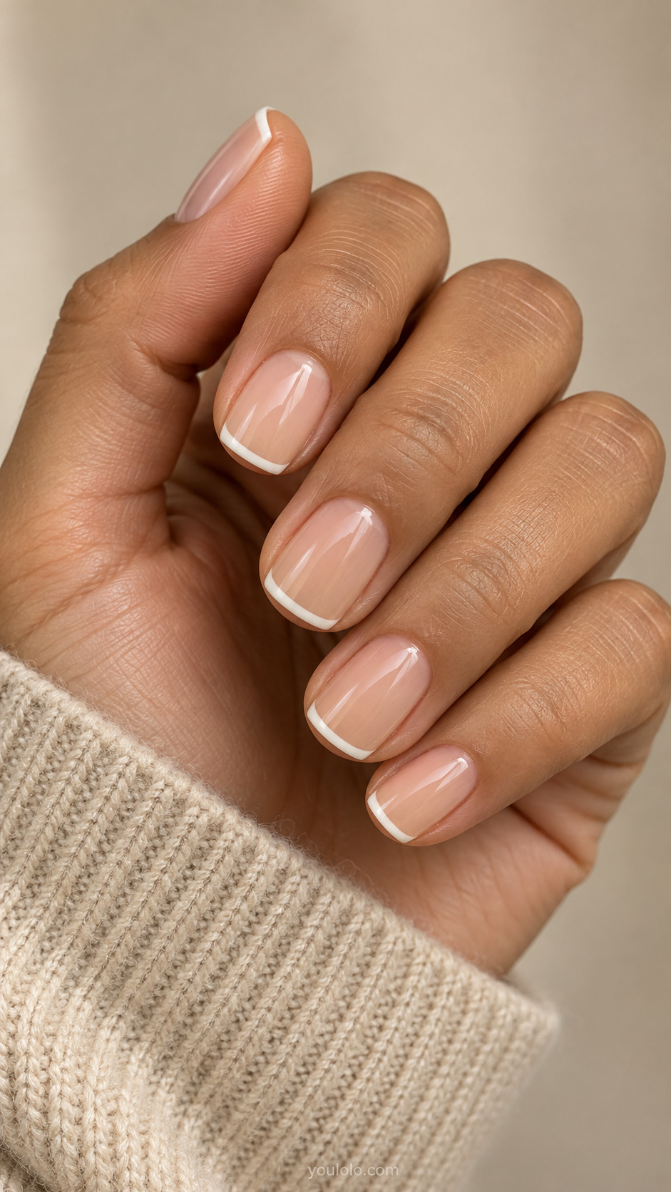 Short soft square nails with a sheer peach nude base and fine ivory French tips.