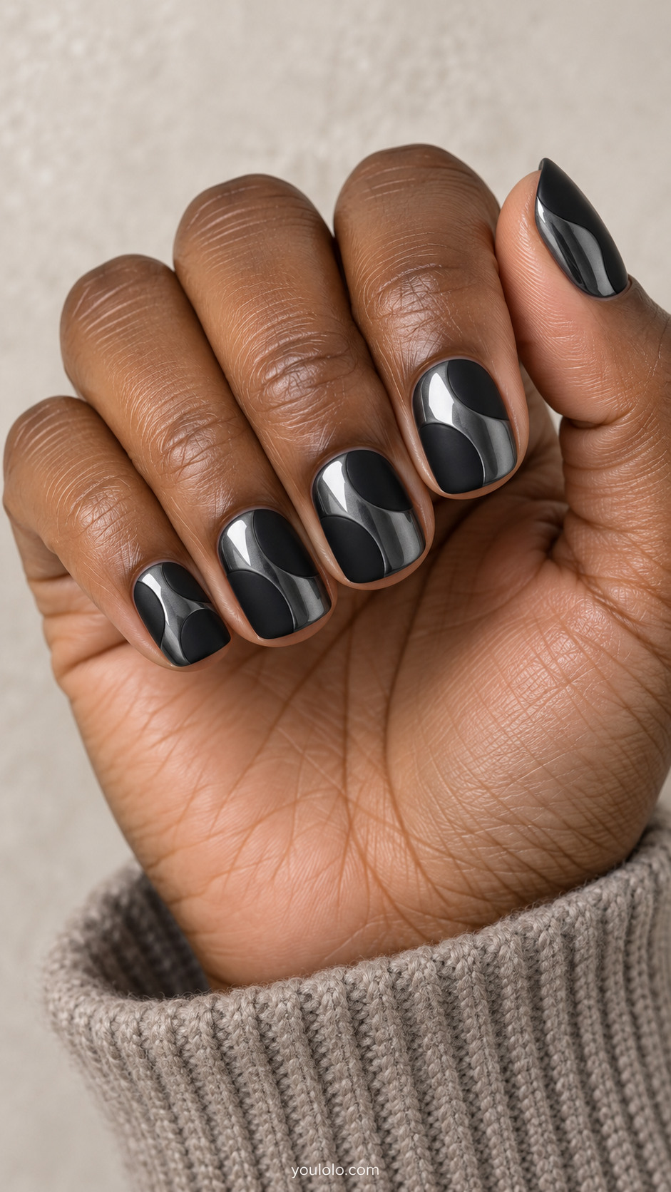 Short rounded-square dark gunmetal mirror nails with two broad asymmetric flat matte-black islands on each nail, large chrome channels between them