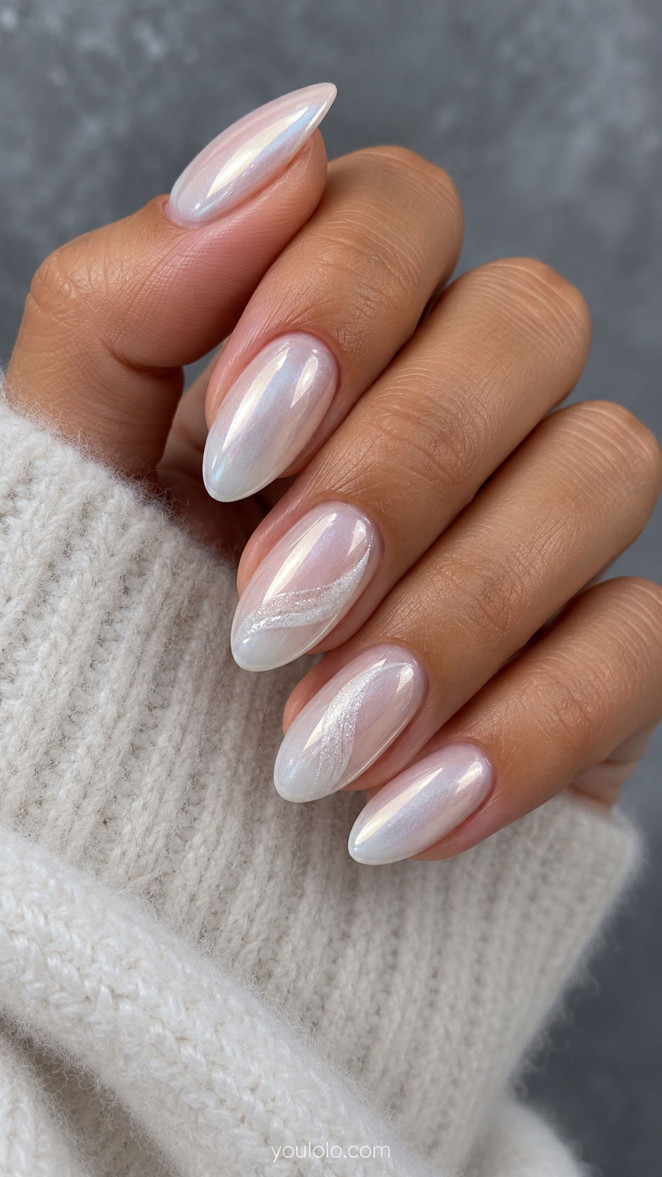 Pearl glaze on almond nails with curved white snowdrift accents on two fingers.
