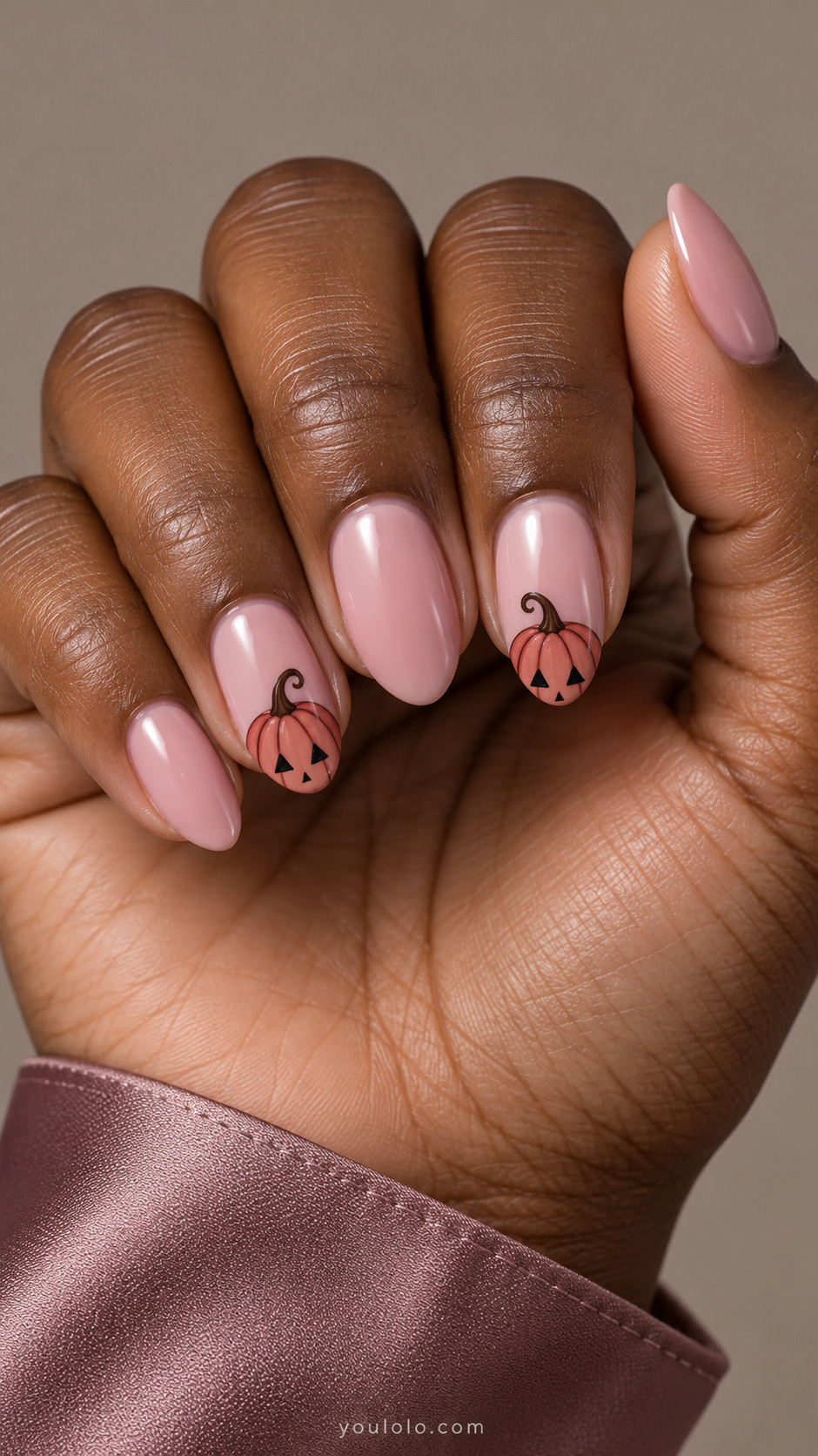 Dusty pink almond nails with rose jack-o-lantern tips and curled brown stems