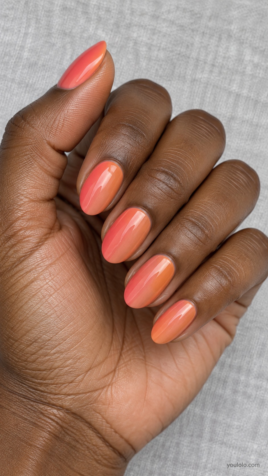 Medium oval nails smooth vertical gradient from soft coral pink on left to muted clay orange on right
