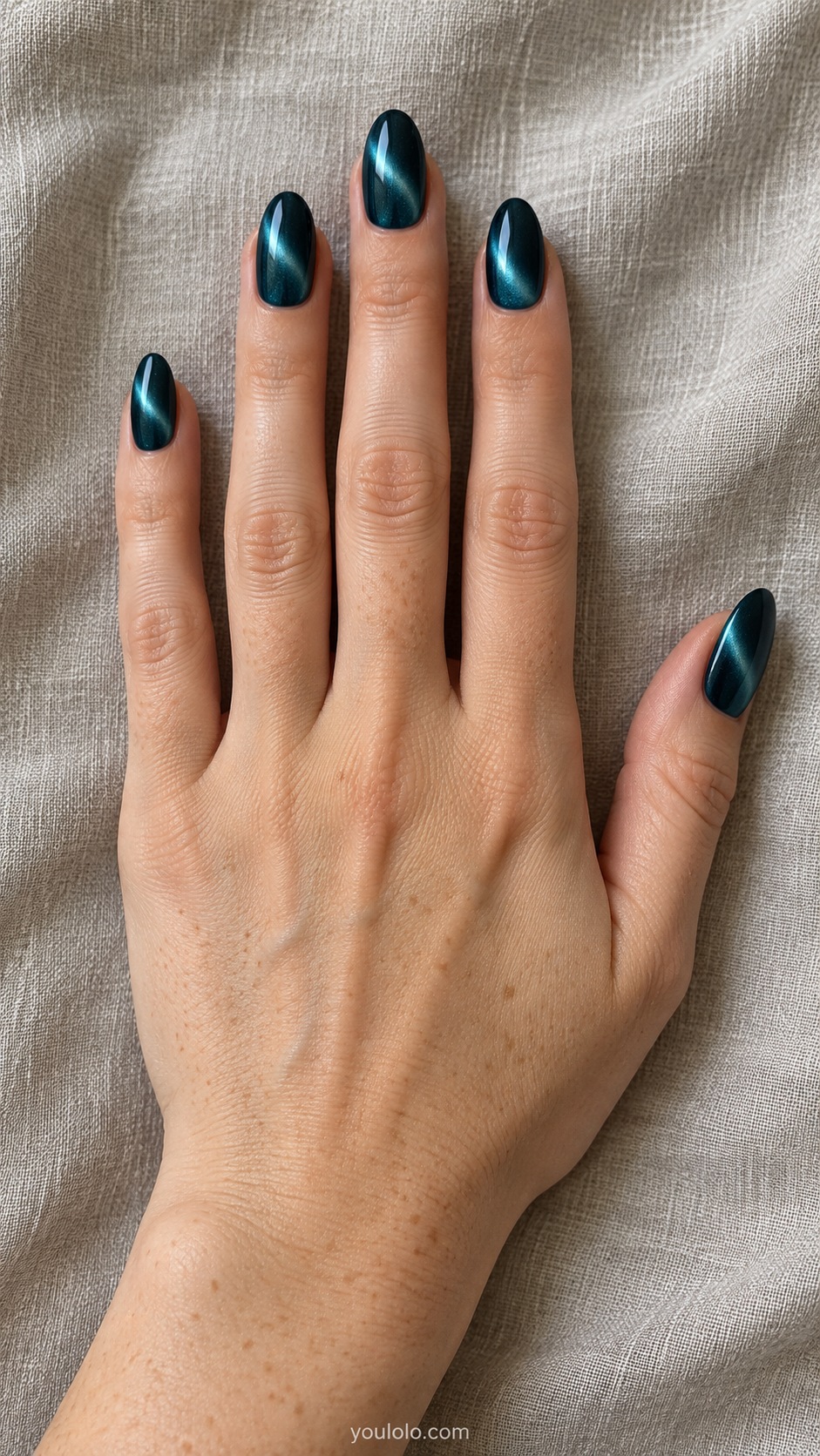 Medium almond nails deep teal magnetic gel with luminous curved crescent reflection