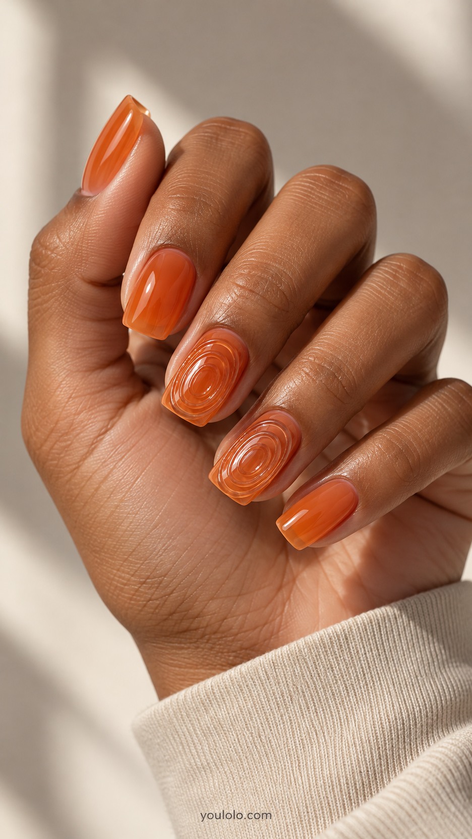 Tangerine Ripple Relief — Medium square nails with translucent tangerine jelly base, raised clear concentric oval ripples like ridged glass on two accent nails, orange smooth jelly remaining nails, no droplets