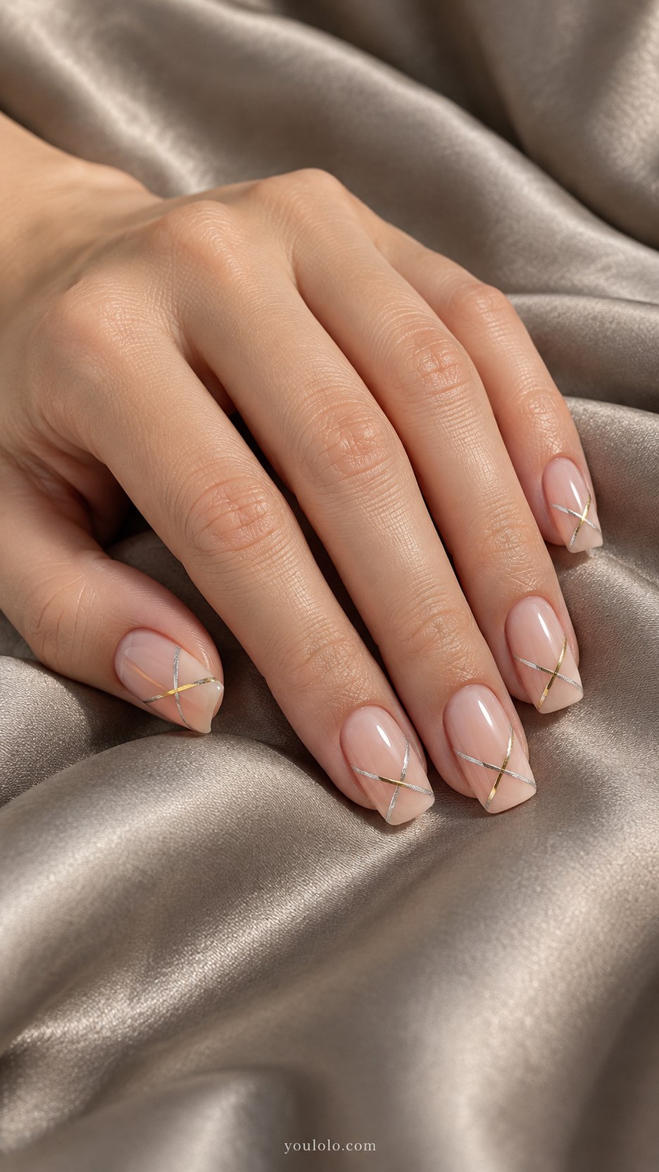 Crossing Metallic Lines: medium square sheer nude nails, one fine silver diagonal crossed by a short fine gold diagonal