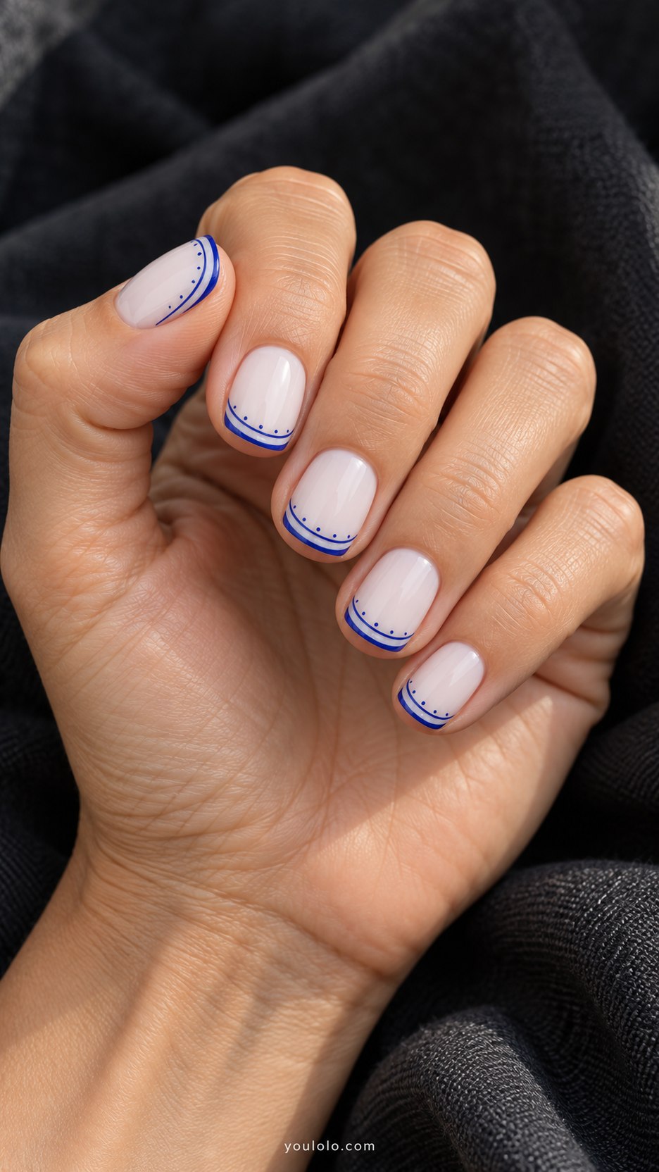 Porcelain Rim French: short square milky white nails, double fine cobalt curved French rim with tiny spaced dots