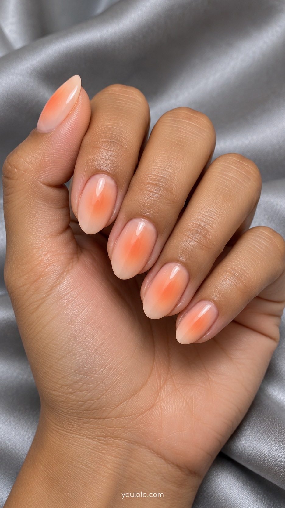 Short Almond Nail Designs: Apricot Aura manicure on a naturally posed hand