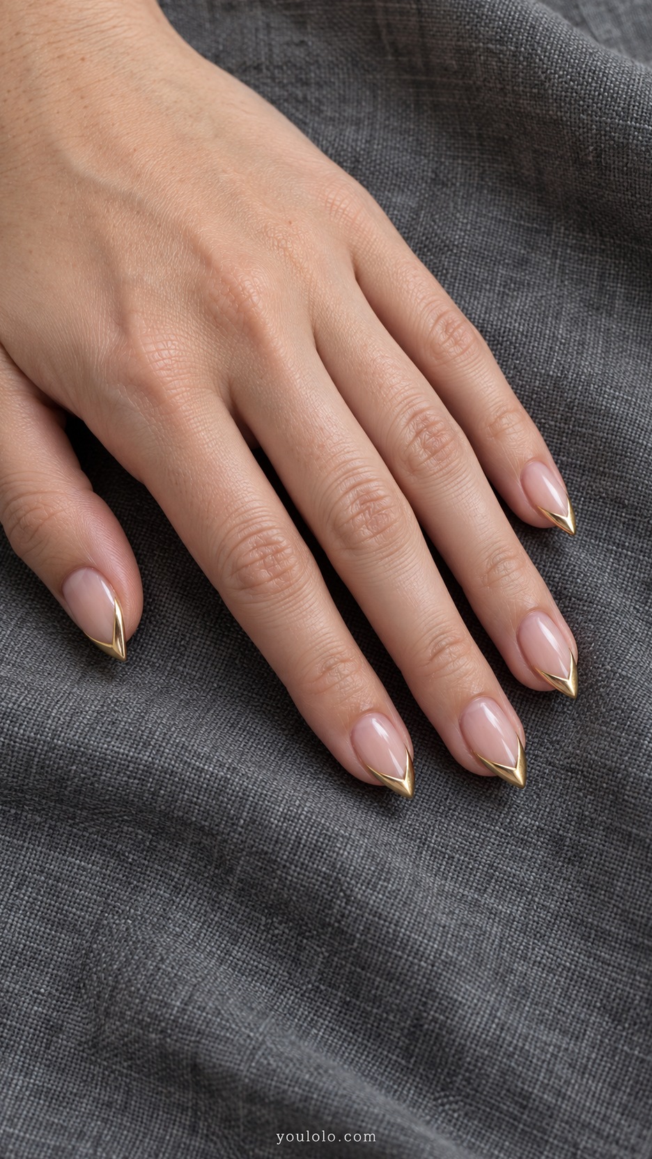 Short Stiletto French Nails: Gold Outline French manicure on a naturally posed hand