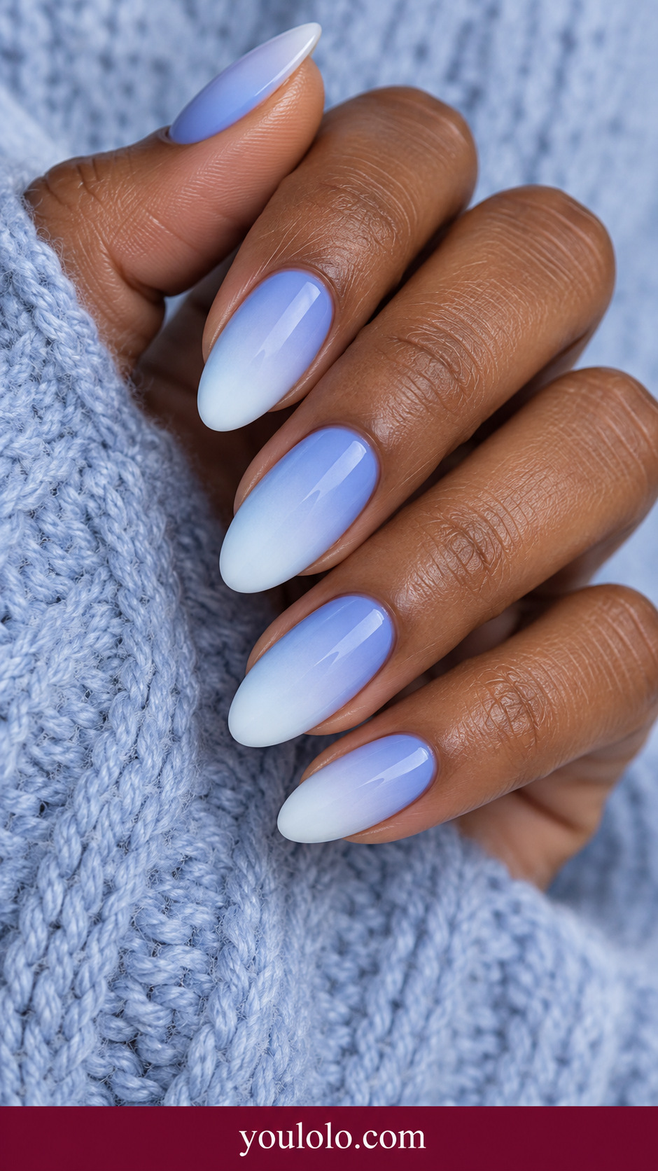 medium almond periwinkle blue at base fading smoothly into pale icy white tips, glossy on a naturally relaxed adult hand