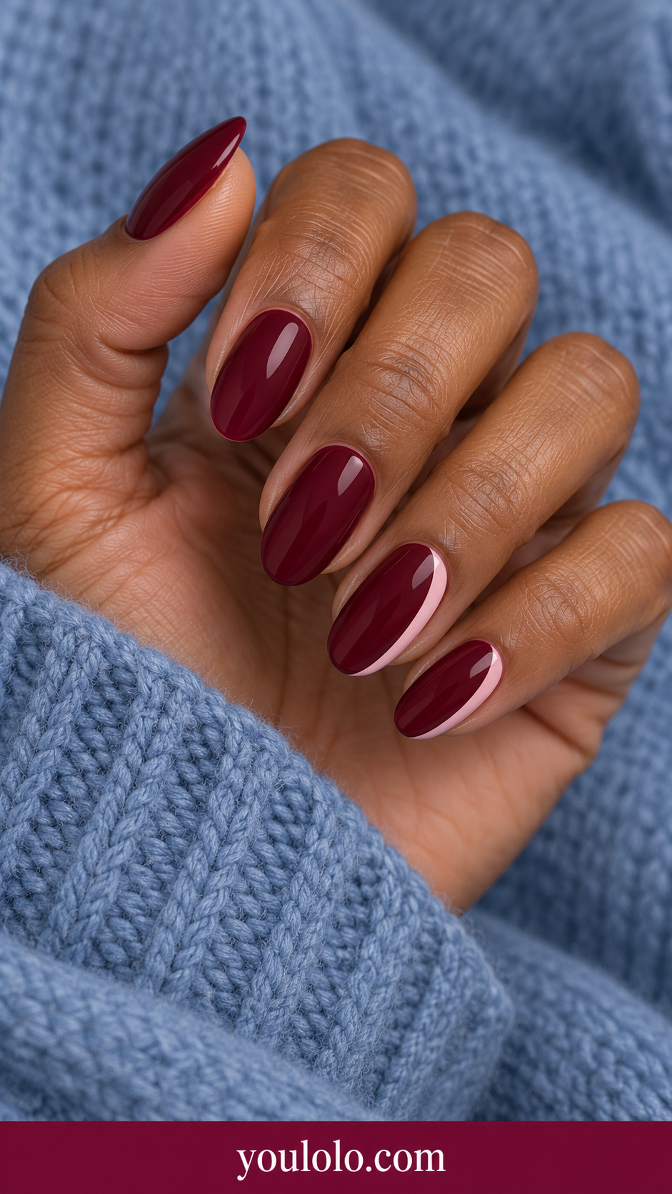 Maroon Pink Crescent: medium oval maroon nails small soft blush pink crescent following one lateral edge on two accents on a naturally posed adult hand