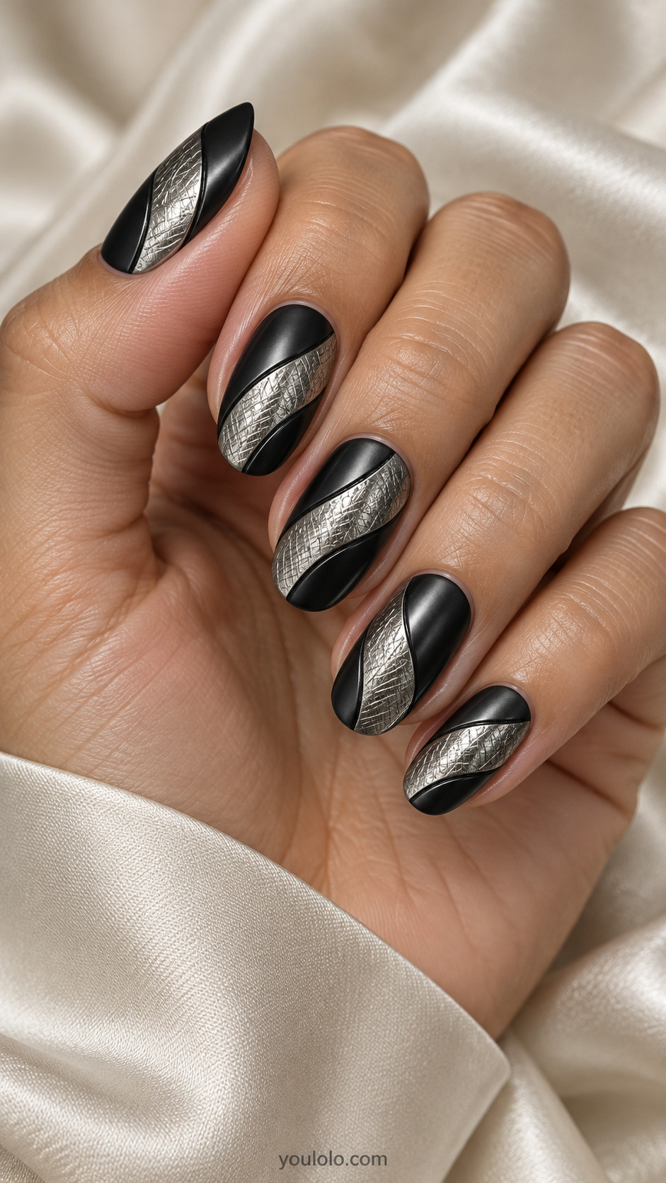 Medium oval satin black nails broad curved silver panels with fine engraved crosshatch texture and crisp black dividing edges, refined industrial jewelry effect