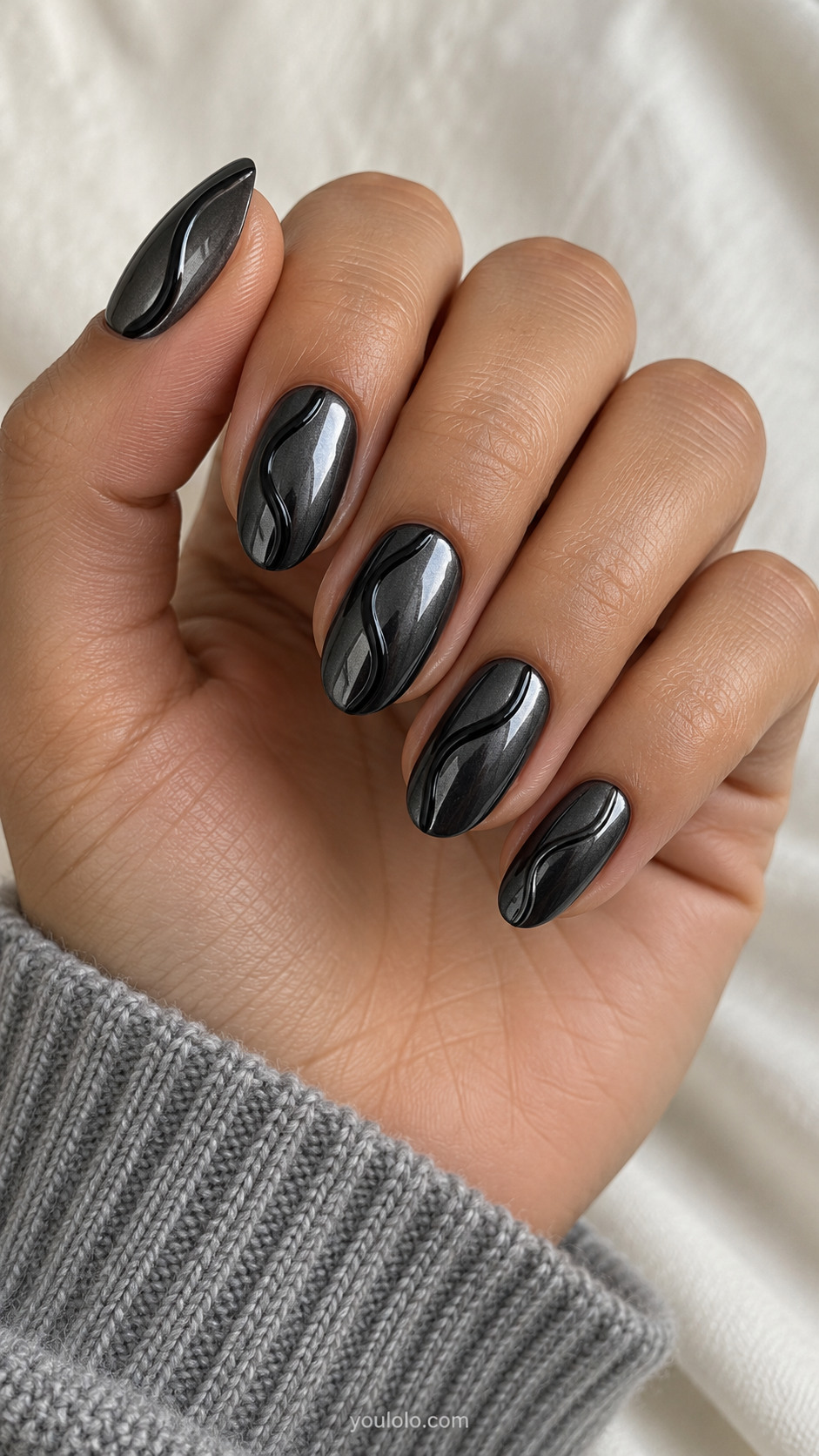 Medium oval dark gunmetal chrome nails with a single thin gently serpentine darker-black glossy raised gel ribbon on each, relief below 0.5mm