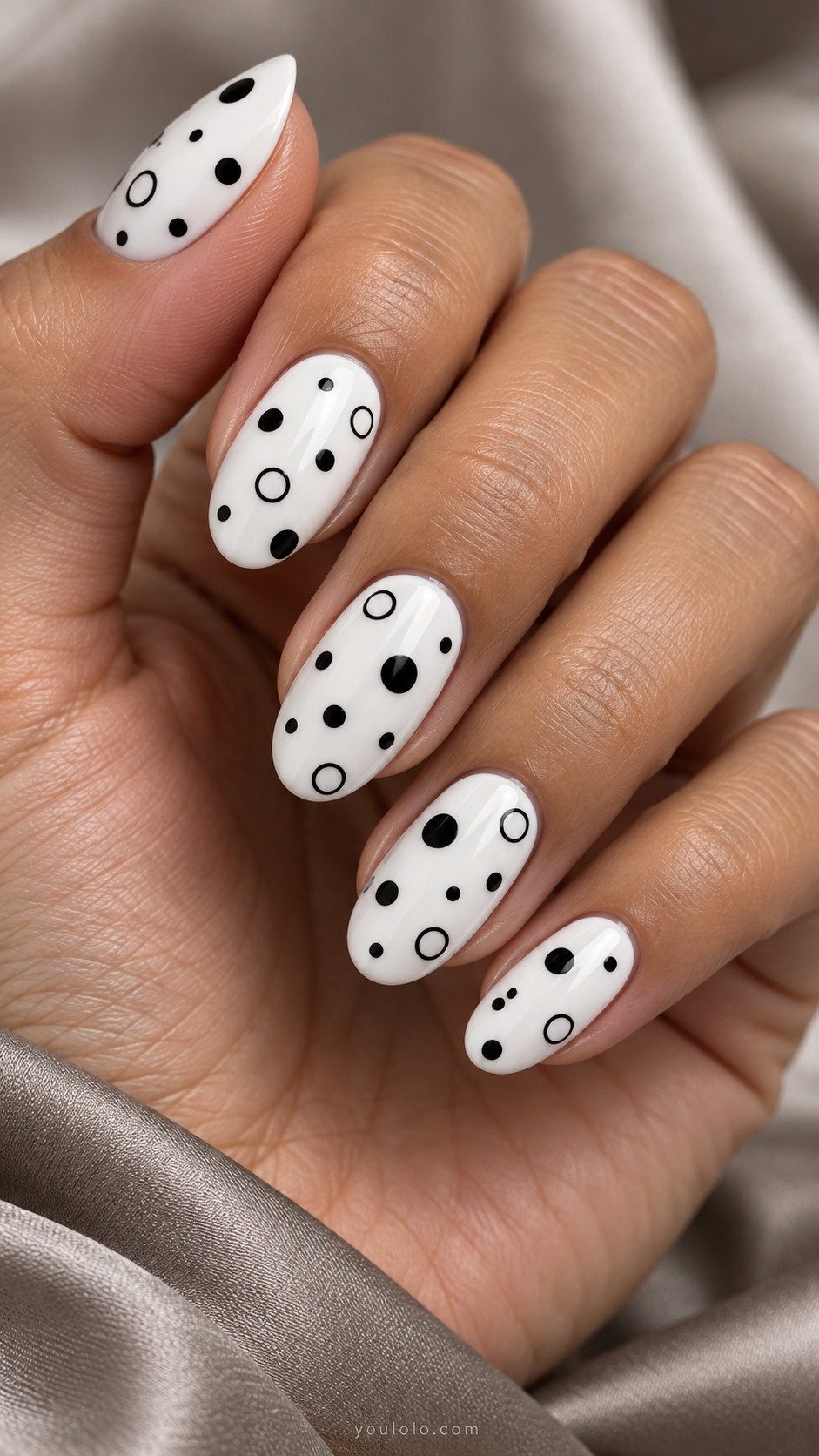 Medium oval white nails with scattered black solid circles alternating thin black open circle outlines, generous spacing
