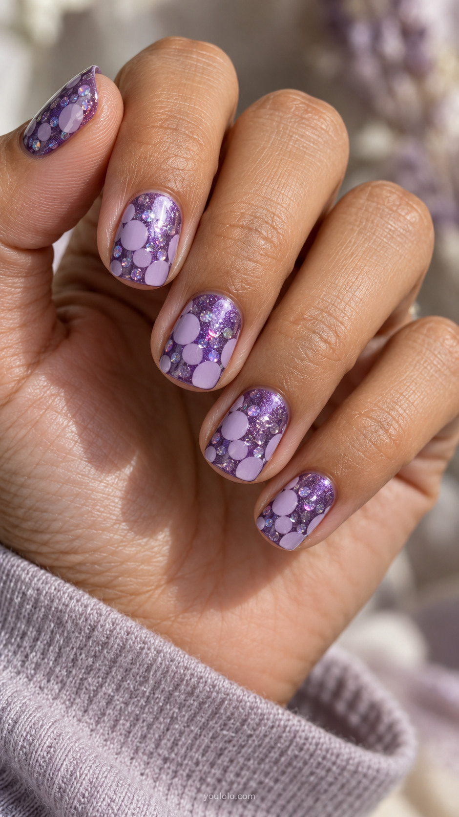 Soft square violet shimmer nails with layered lilac and holographic circles.