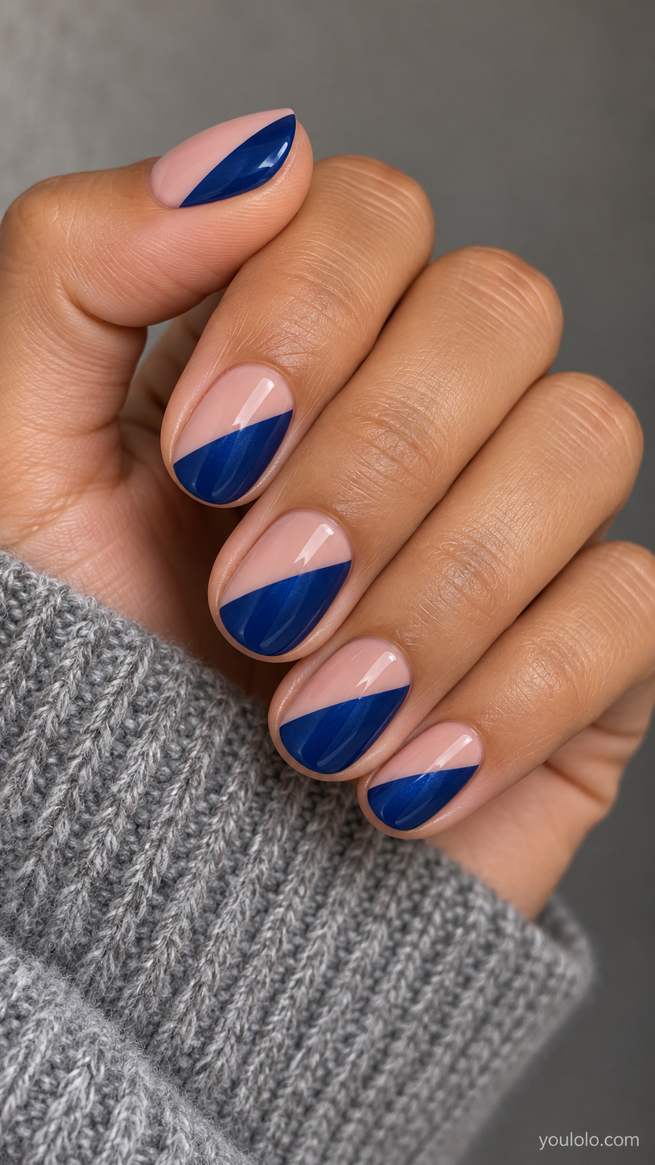Sapphire and Blush Diagonal Dip on a softly gathered feminine hand with detailed sapphire blue manicure