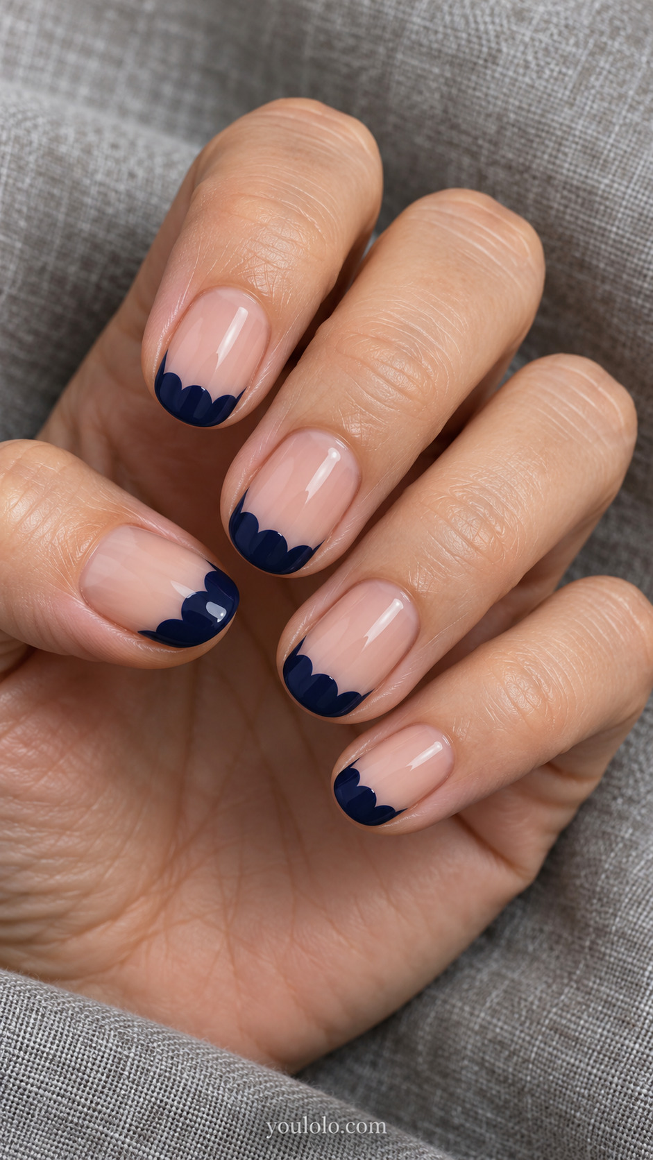 Scalloped Midnight Tips on a naturally posed hand, showing dark blue polish and detailed nail art