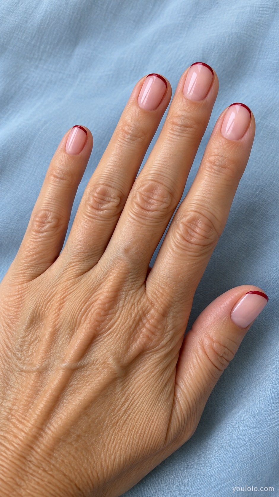Short round nails milky summer pink base with hairline cranberry red French rim