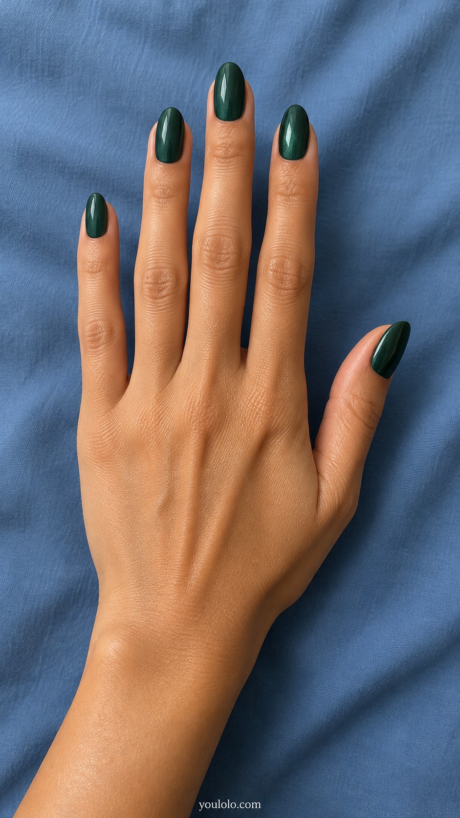 Medium oval deep forest green with subtle cool white pearlescent reflection no magnetic stripe