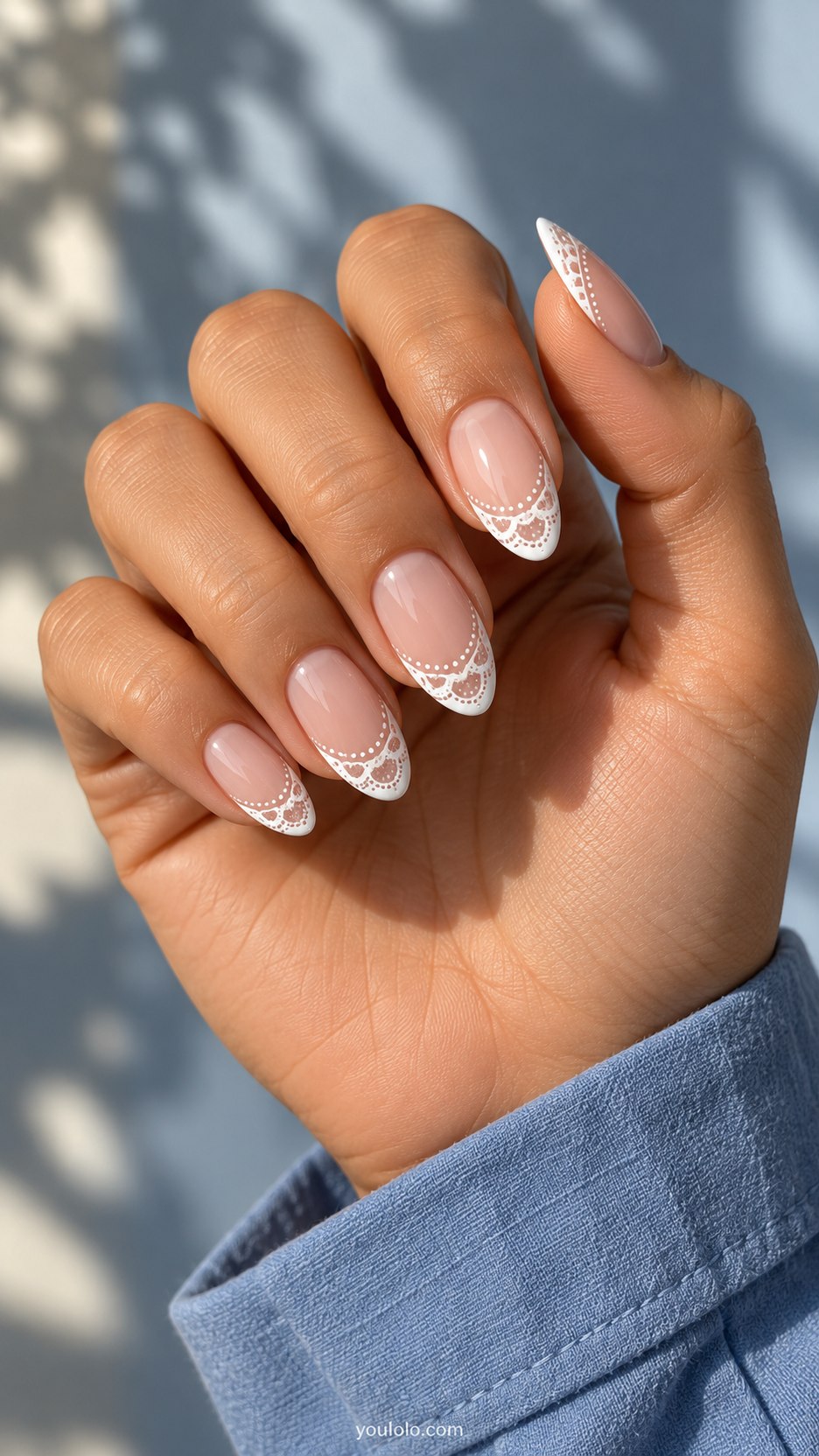 Scalloped Lace French: medium almond nude nails, white French tips formed from scalloped lace arches and tiny dots