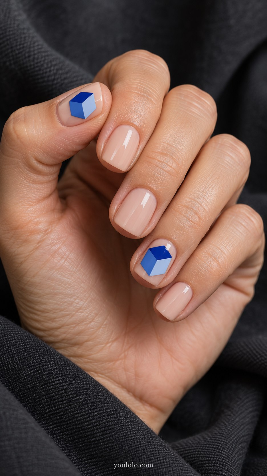 Cobalt Floating Cube: short square nude nails, one flat painted cobalt three-tone isometric cube on two accents