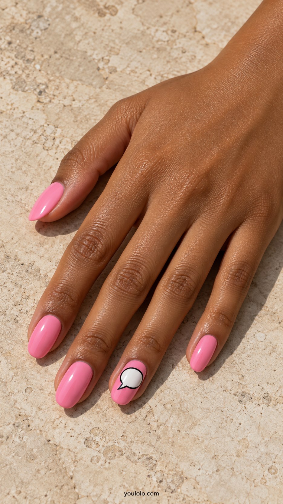 Pink Speech-Bubble Accent: medium oval bubblegum pink nails, one white black-outlined empty speech bubble on ring nail, no words