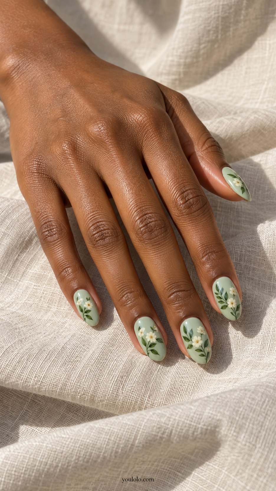 Celadon Painted Leaves: medium oval pale celadon nails, fine forest green leaf sprigs and tiny cream flowers, smooth ceramic gloss