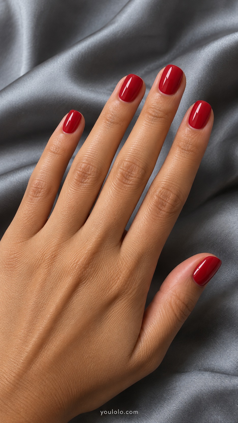 Short Press-On Nails: Cherry Red Round manicure on a naturally posed hand