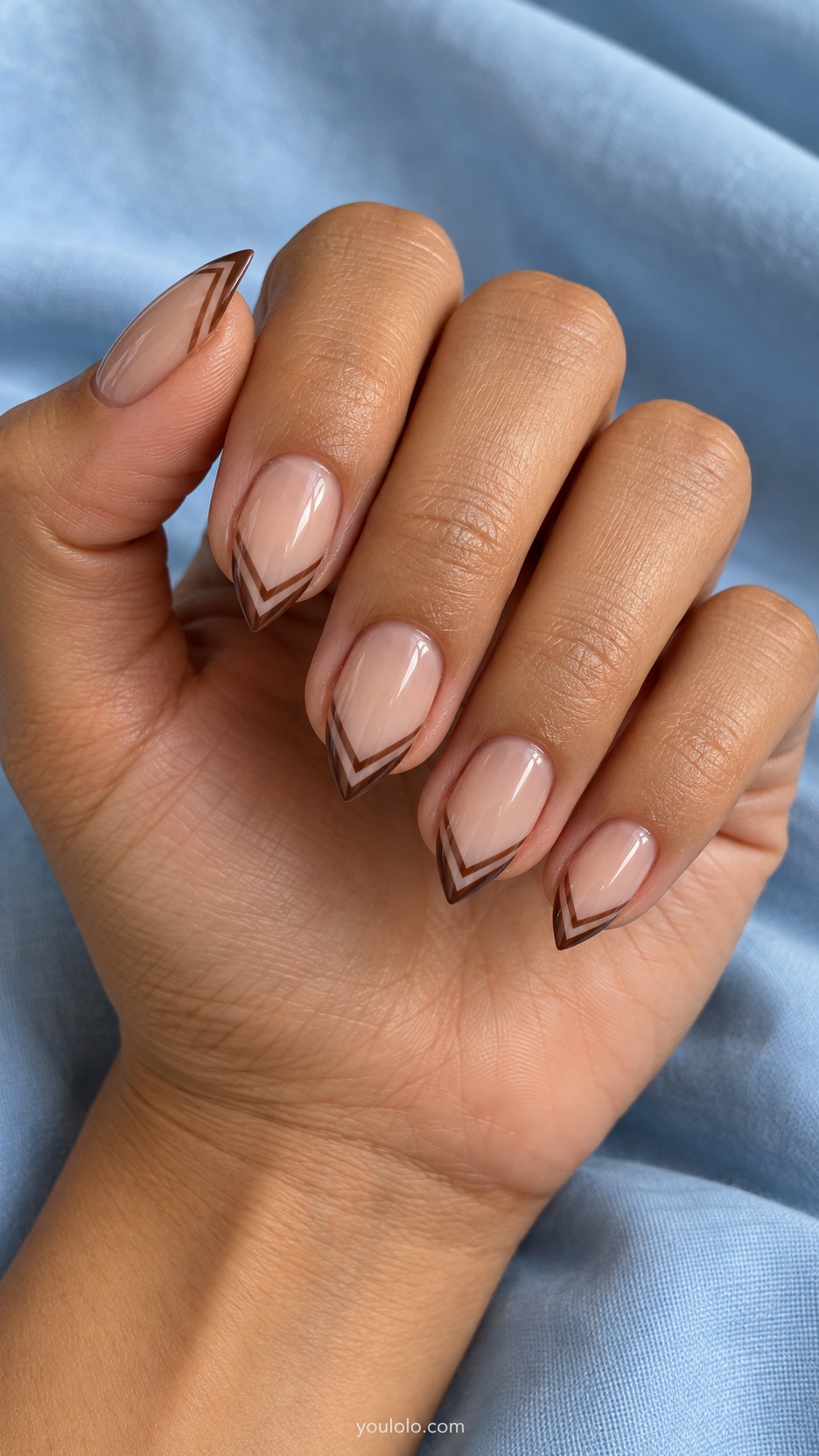 Short Stiletto French Nails: Chocolate Double V manicure on a naturally posed hand