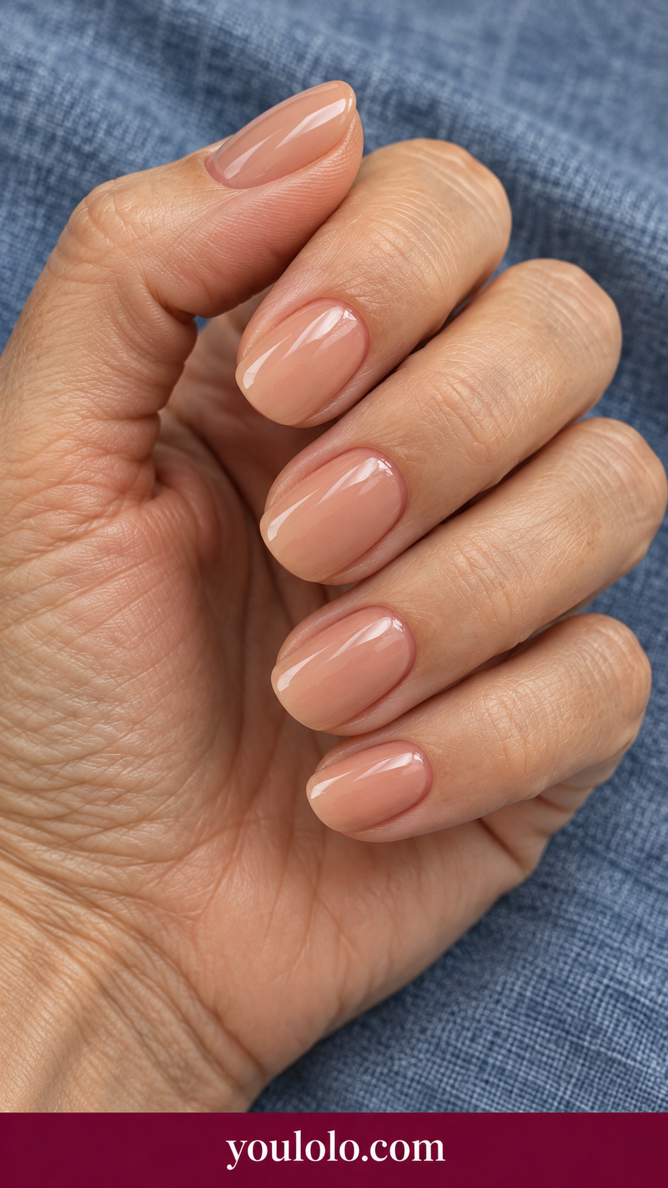short squoval opaque warm milk tea beige press-on nails glossy plain on a naturally posed adult female hand