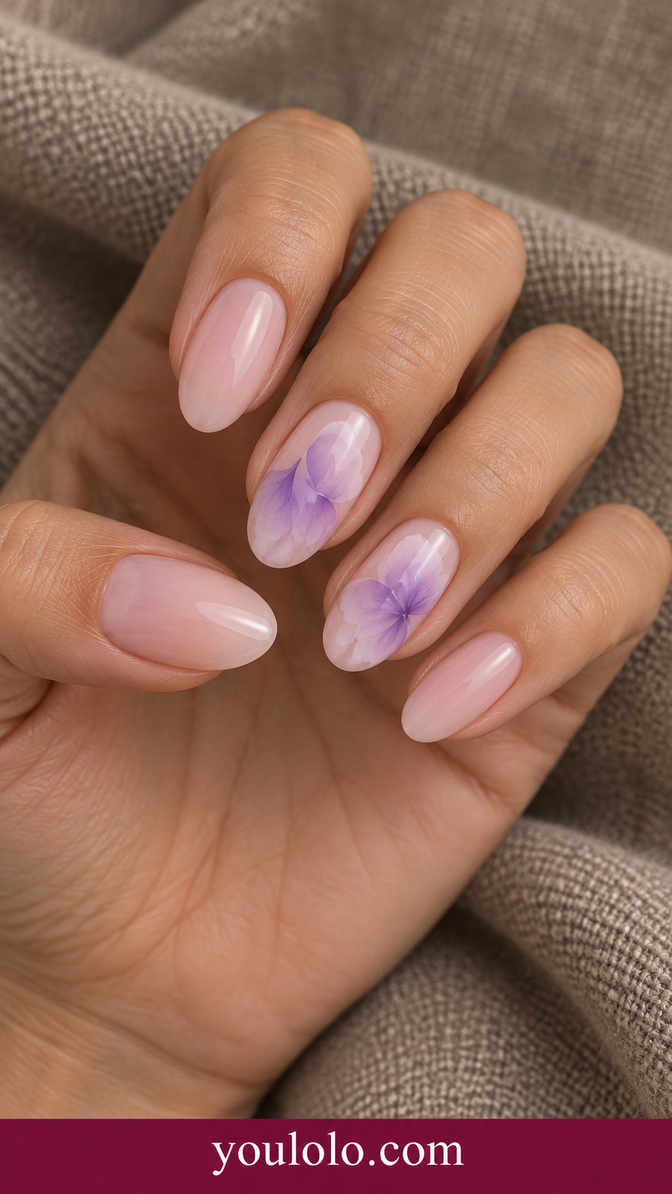Lavender Petal Drift: medium oval sheer pink nails ring and middle delicate lilac blooming petals with soft diffuse edges on a naturally posed adult hand