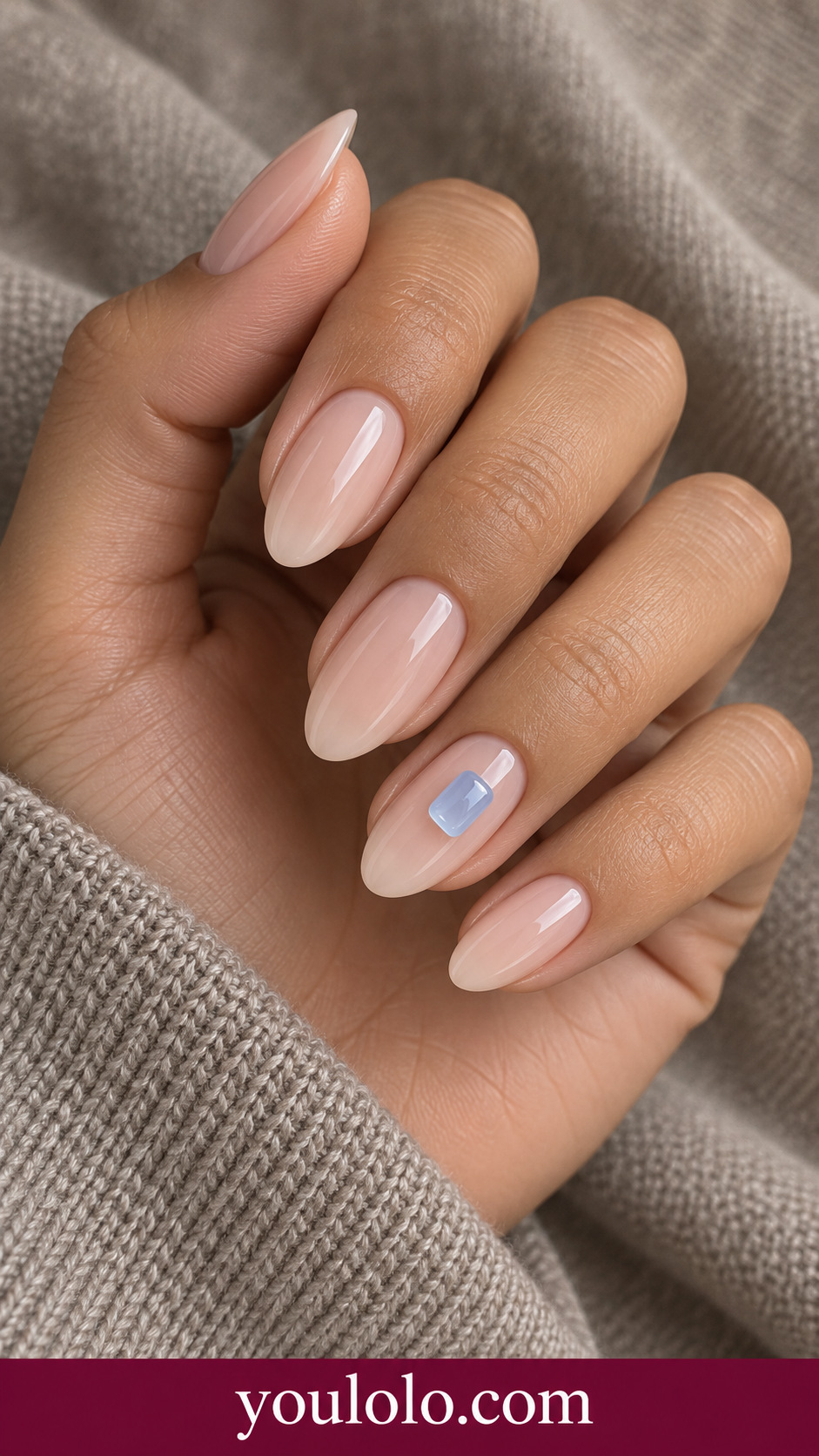 Soft Blue Jelly Tile: medium almond sheer nude nails one accent small translucent pale blue gel tile with rounded corners low profile on a naturally posed adult hand