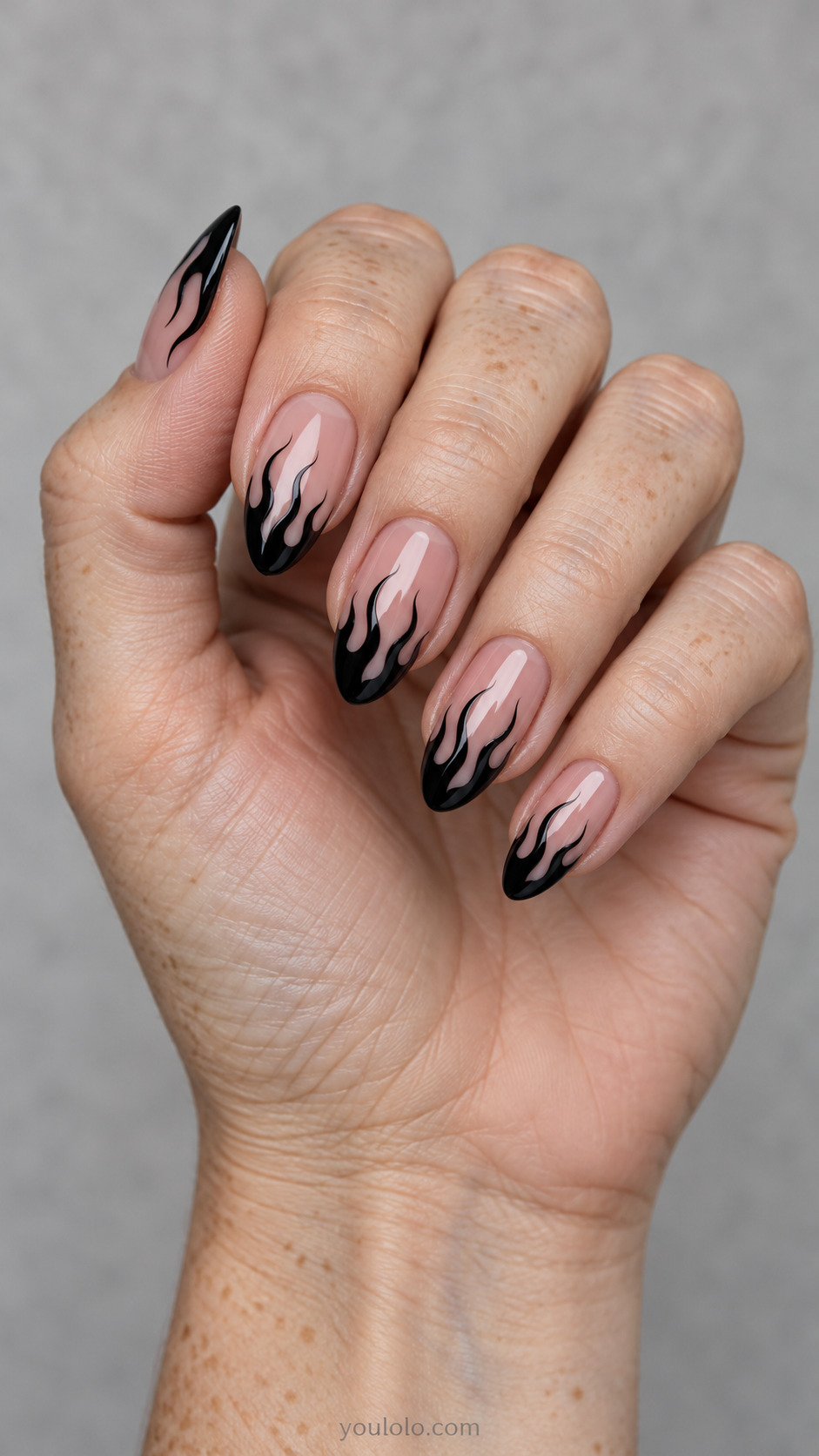 Black Flame French on almond nails with a nude base
