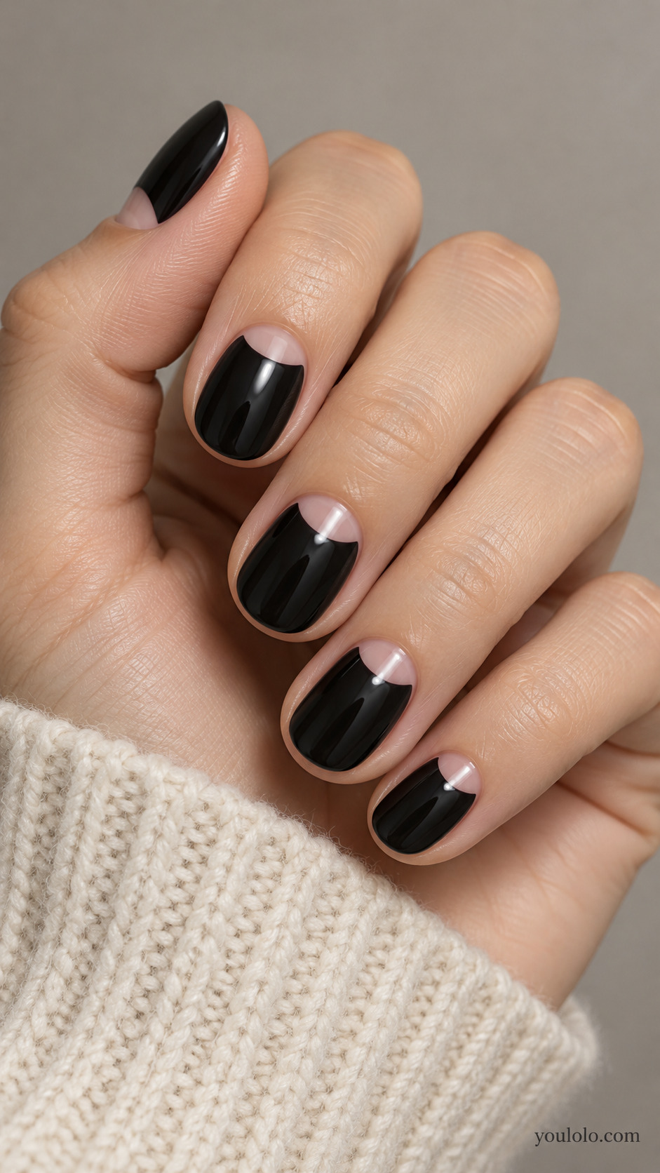 Short black nails with nude half moons at the cuticles